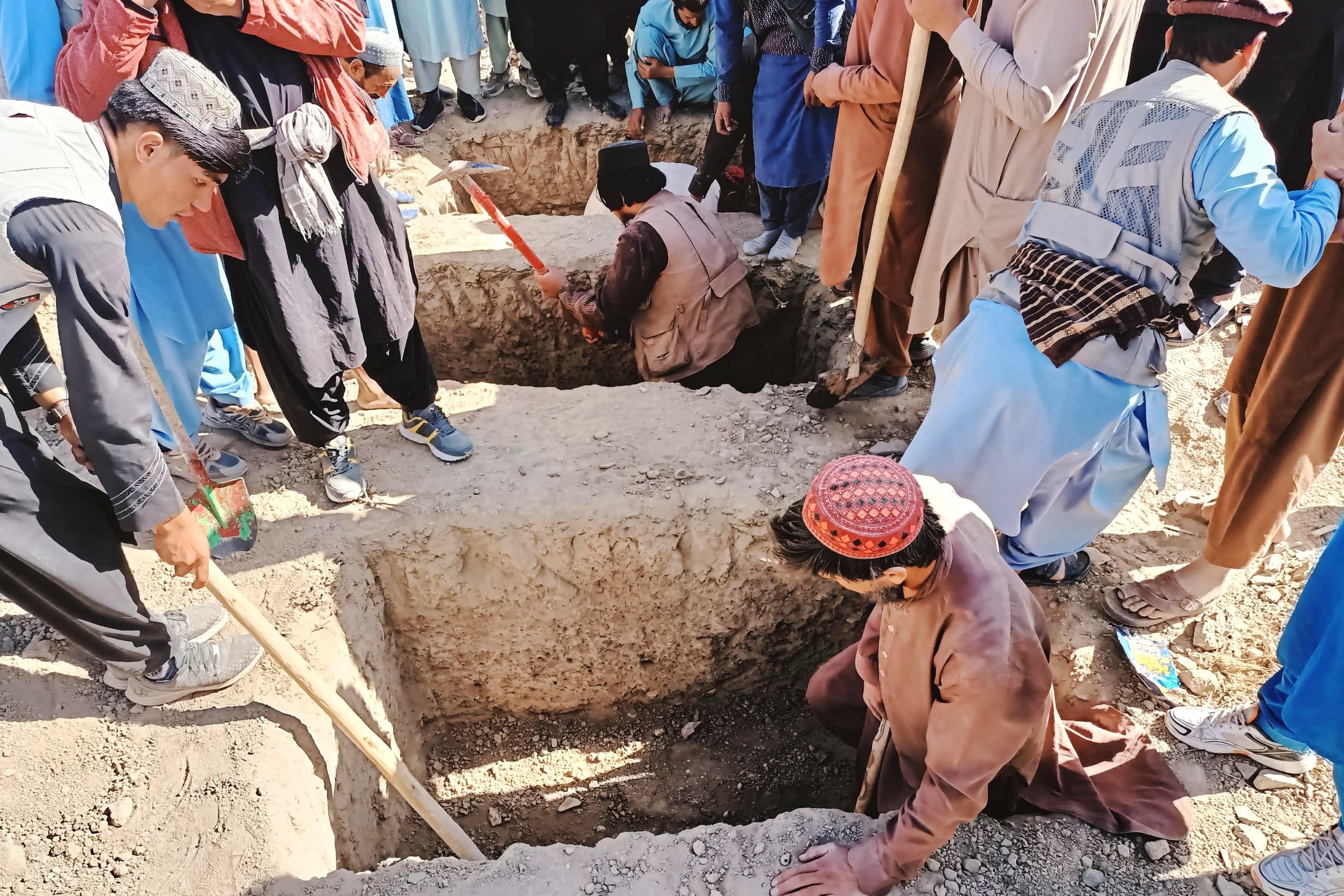 Residents dig graves for those killed in a cross-border airstrike by the Pakistani army in Paktika province, eastern Afghanistan
