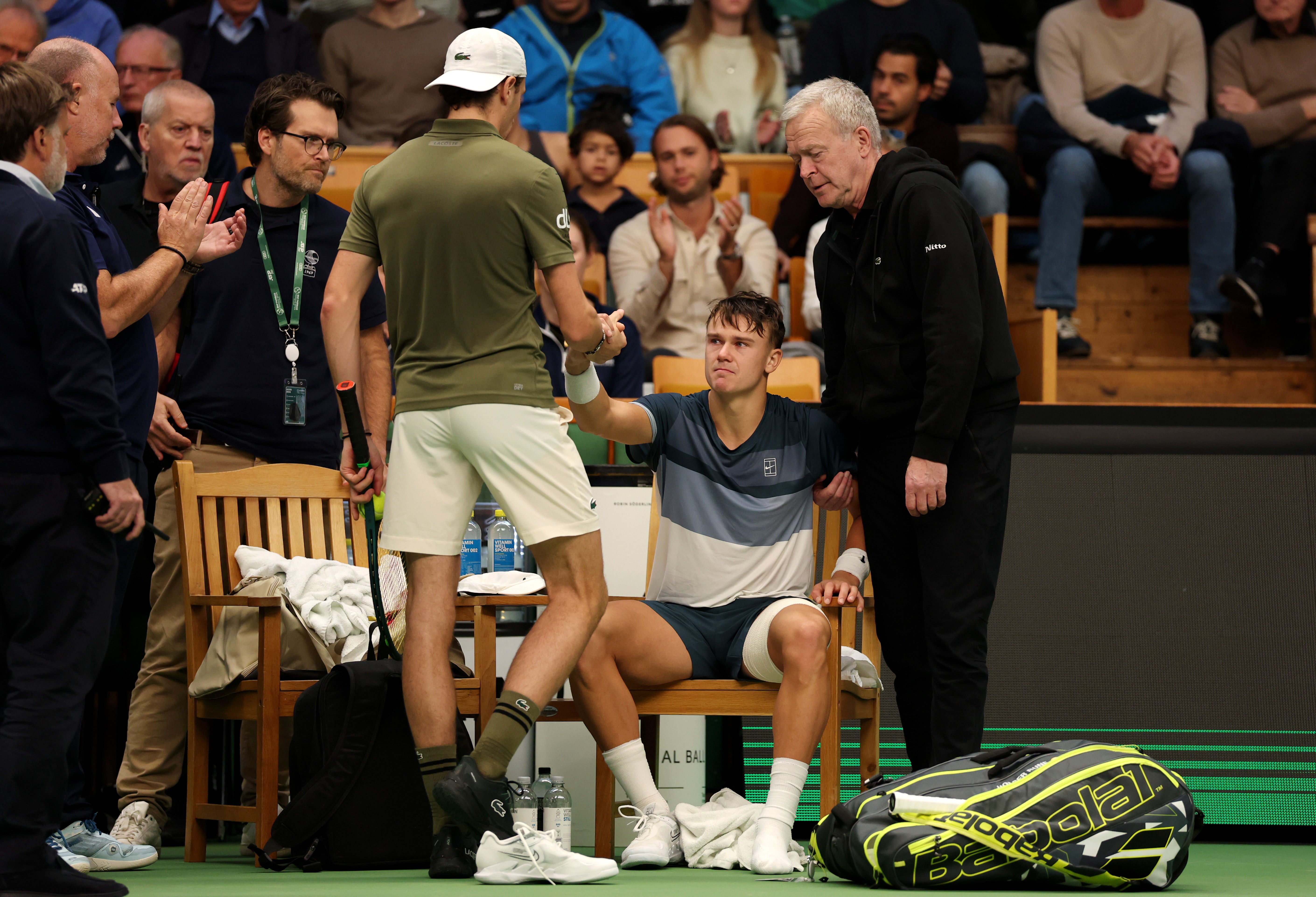 Rune shakes hands with Humbert after retiring from the match