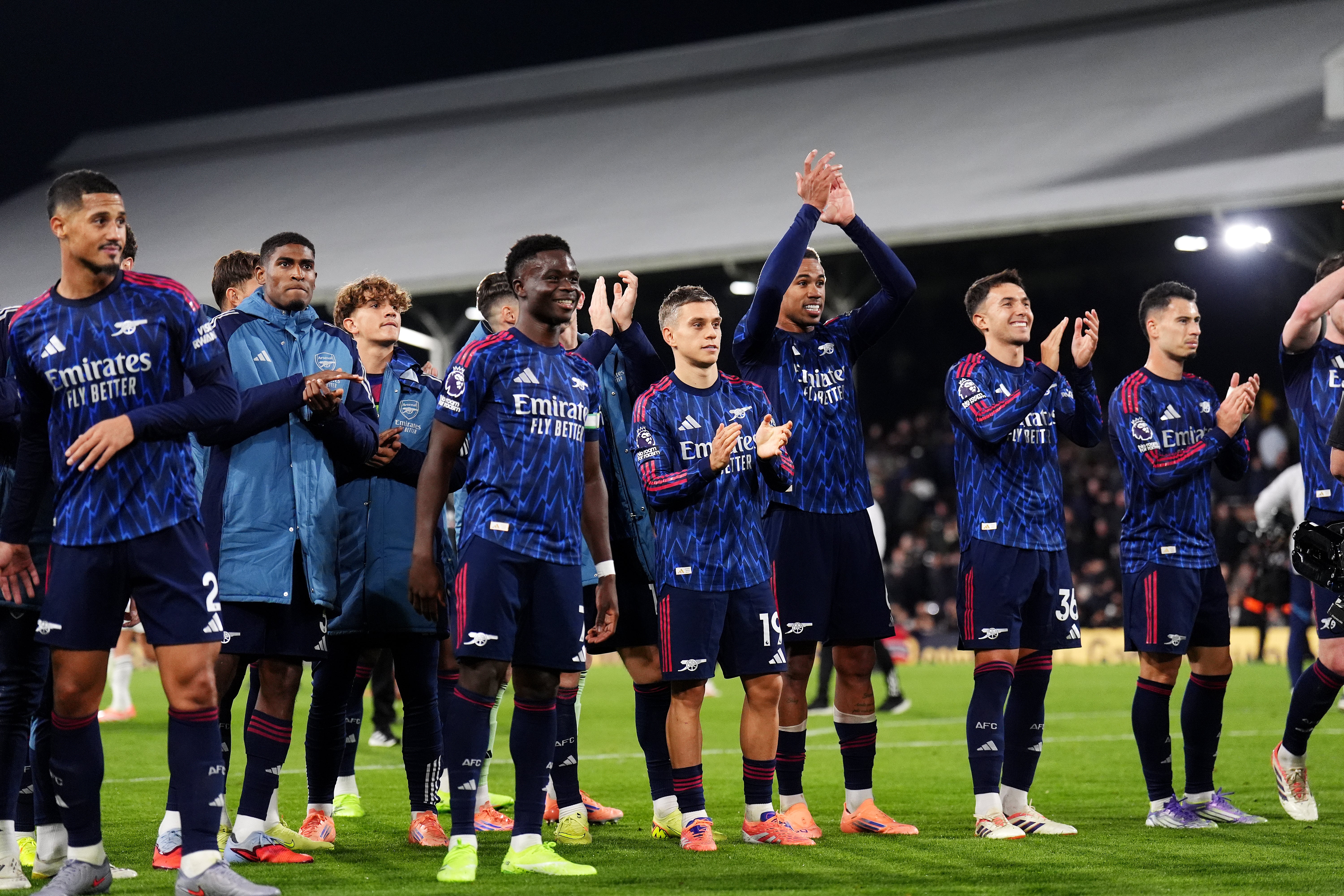 Arsenal players celebrate their hard-fought win at full-time