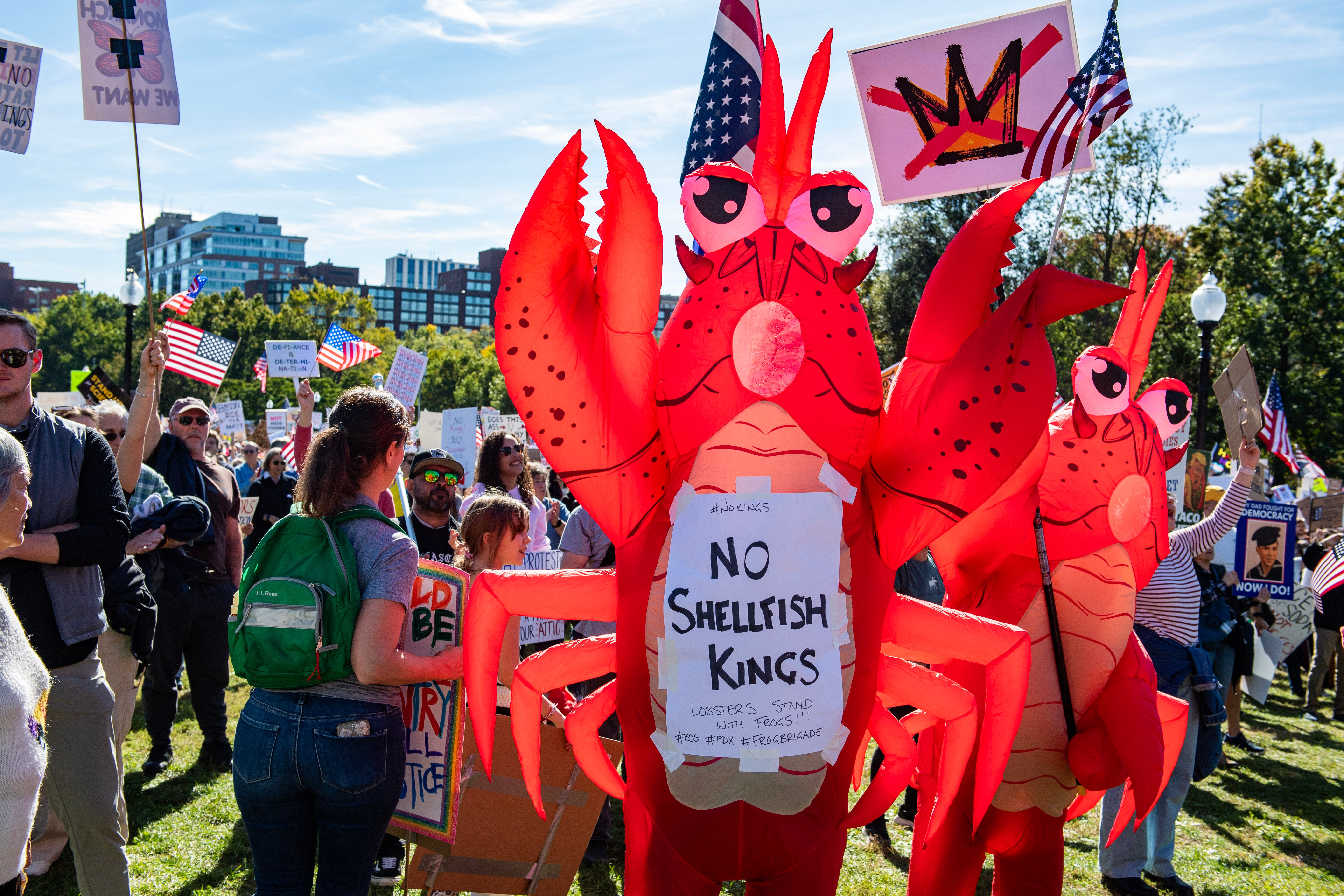‘No shellfish kings,” read a sign held up by one protester, wearing a lobster costume, in Boston, Massachusetts