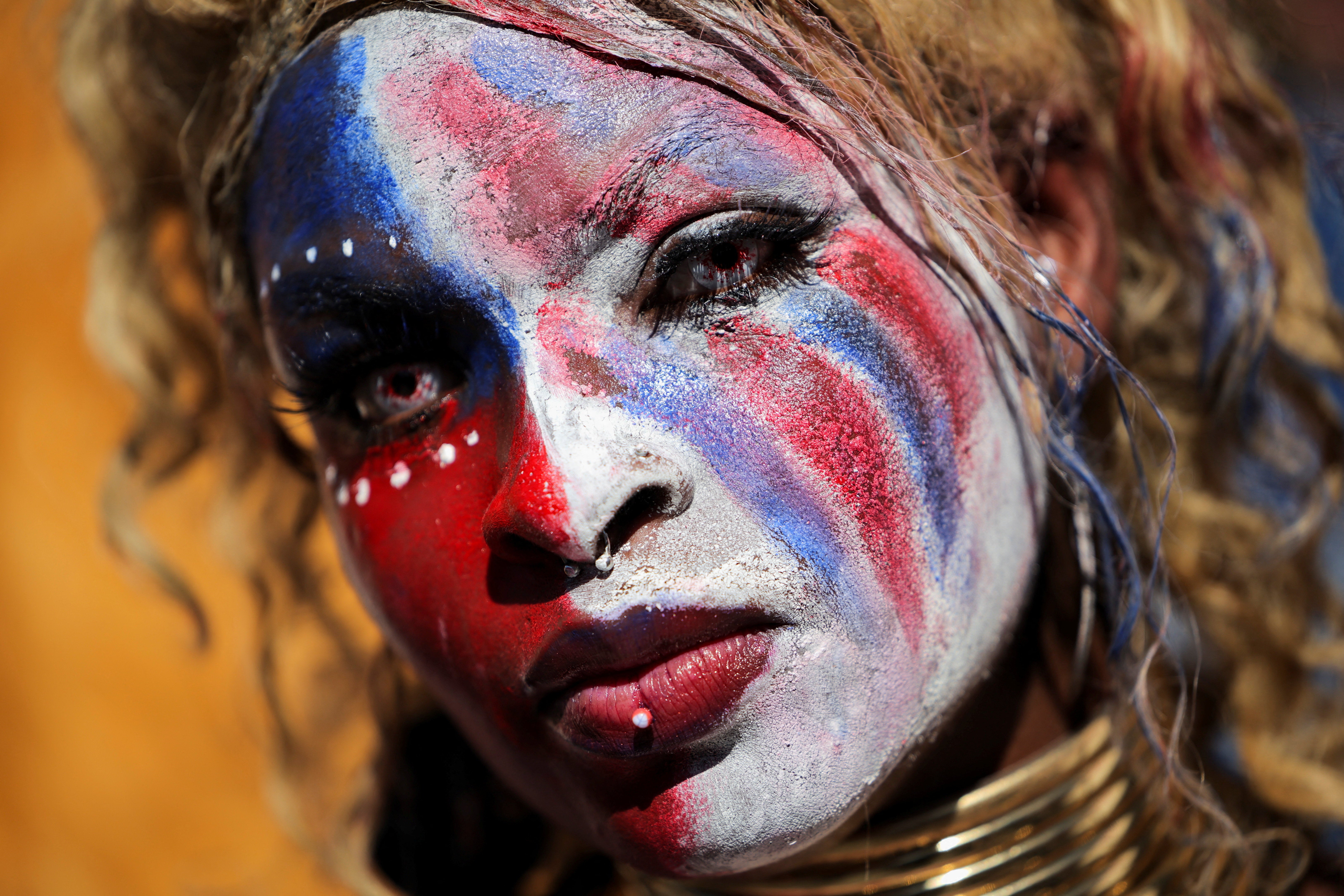 A protester wearing makeup in the colours of the U.S. flag at a rally outside City Hall in Los Angeles, California