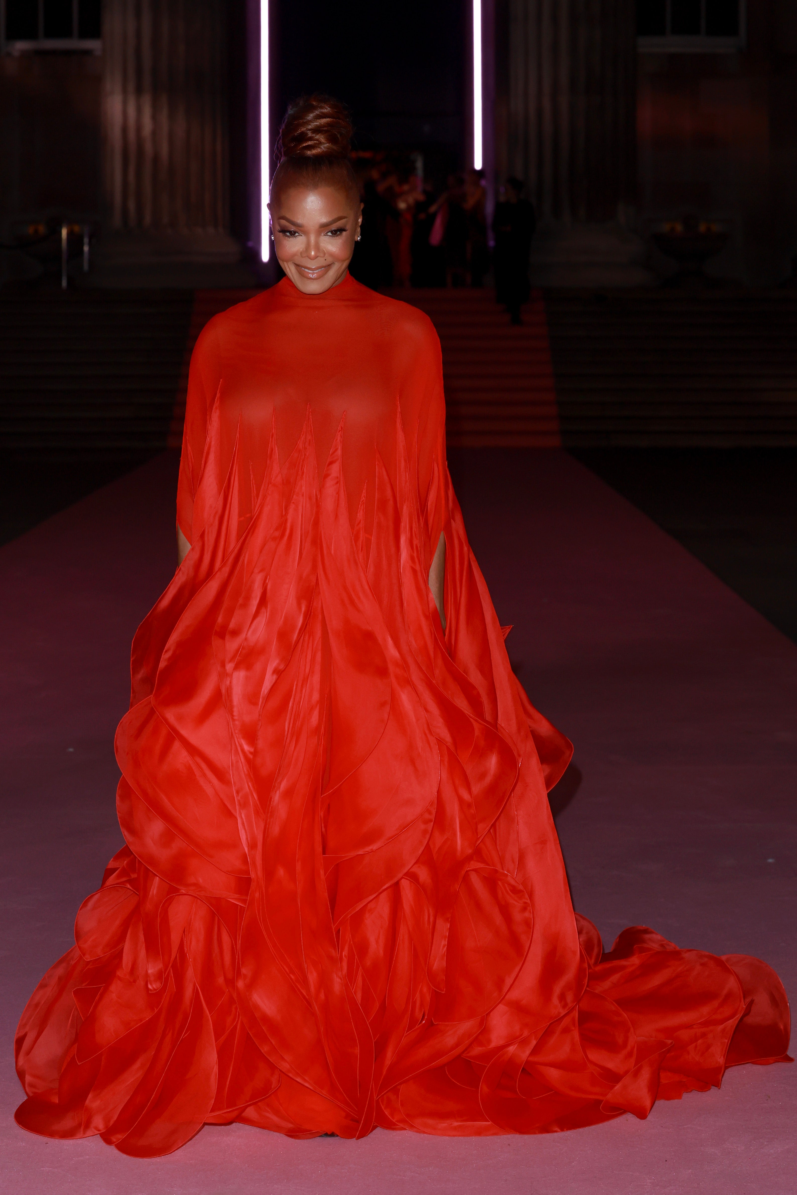 Janet Jackson attended the British Museum Ball wearing a long, flowing and demure red dress