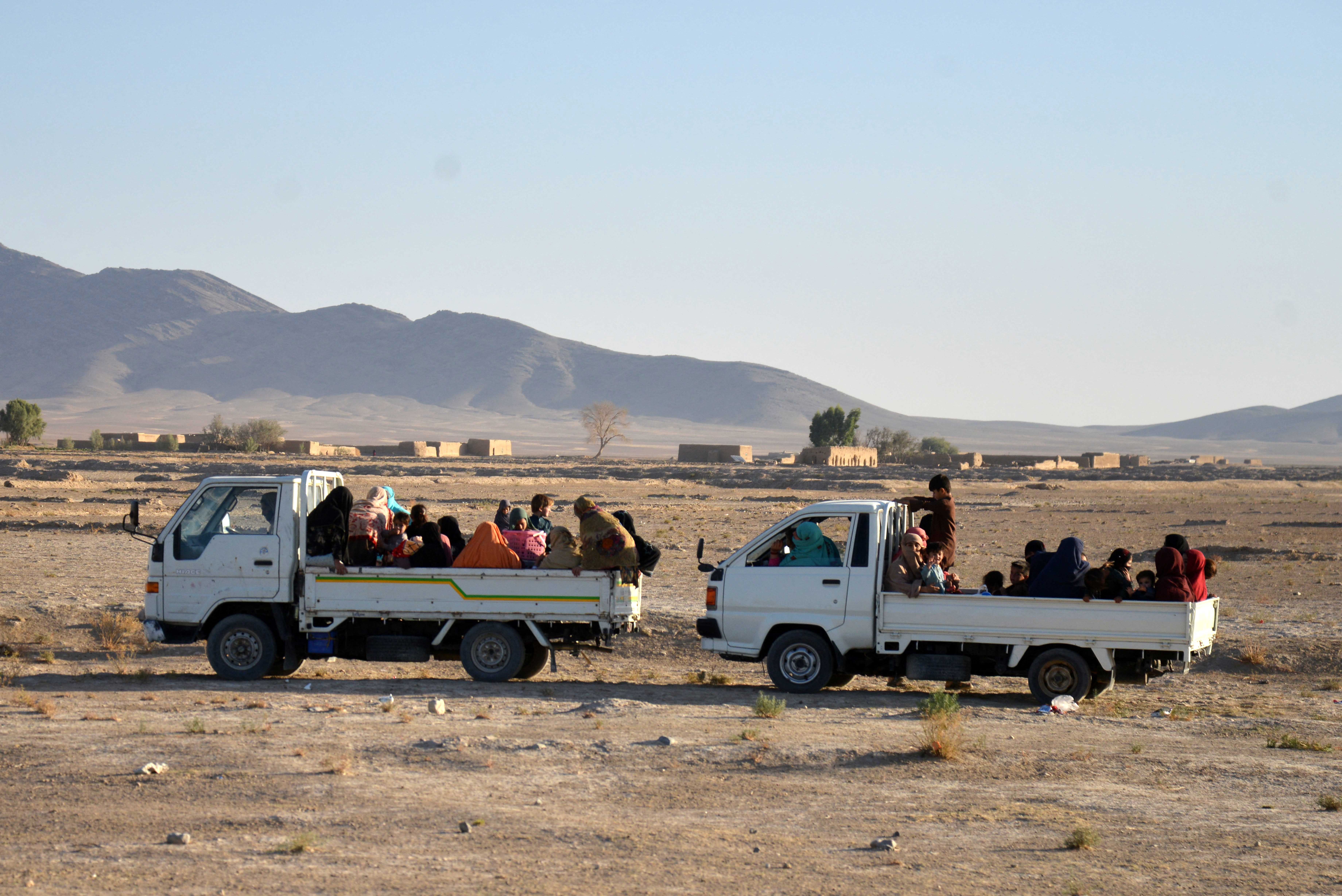 Afghan women and children are evacuated via trucks during ongoing clashes between Taliban security personnel and Pakistani border forces in the Spin Boldak district of Kandahar Province on October 15, 2025