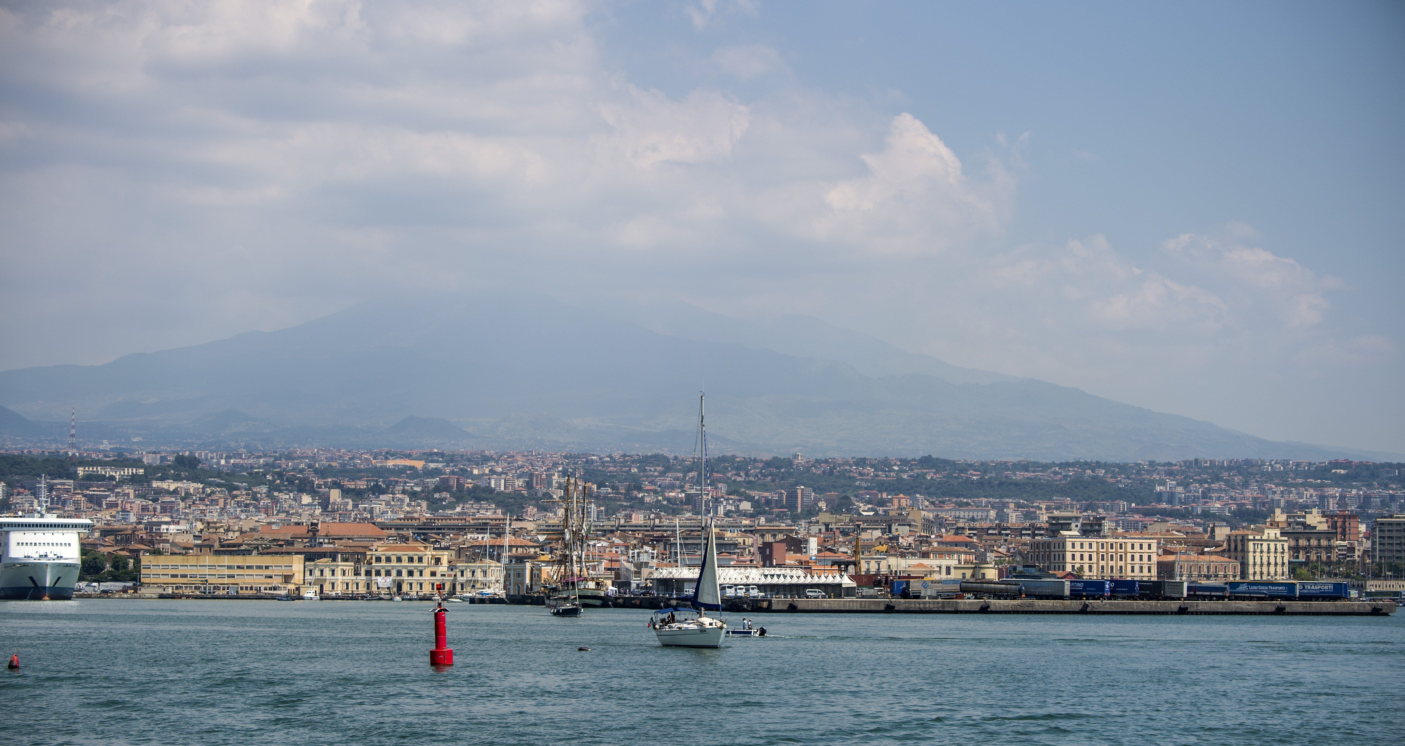 A sail boat is seen leaving the harbour in Catania, Sicily