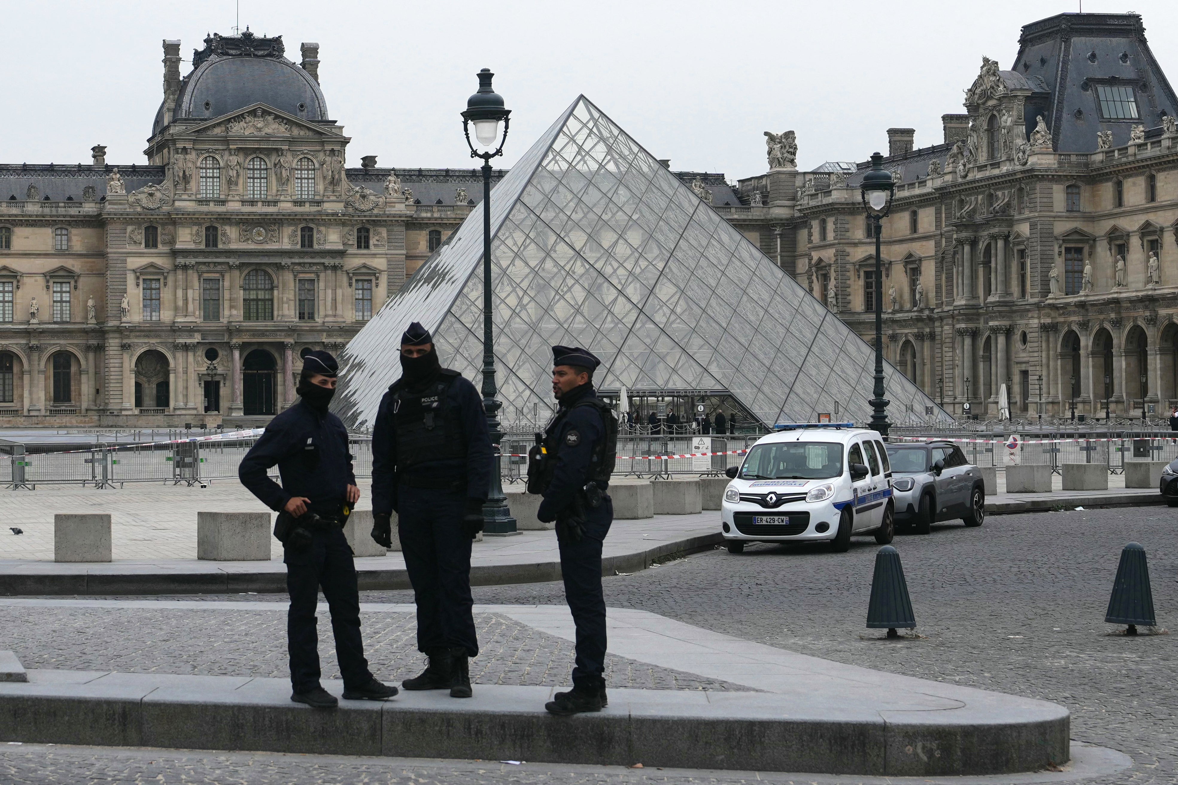 French police officers stand in front of the Louvre after the incident