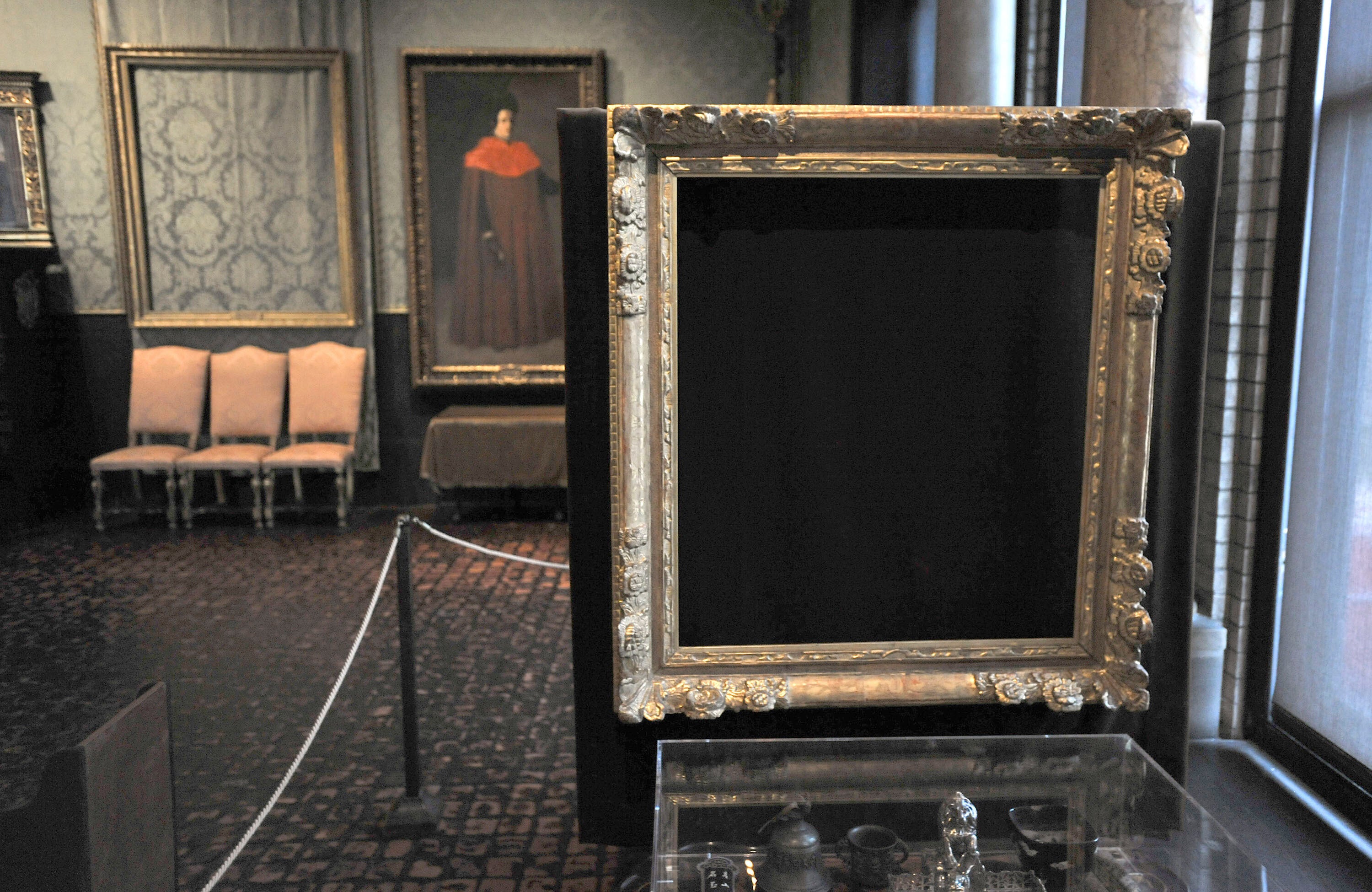 Empty frames from which thieves took Storm on the Sea of Galilee, left background, by Rembrandt and"The Concert, right foreground, by Vermeer, on display at the Isabella Stewart Gardner Museum in Boston