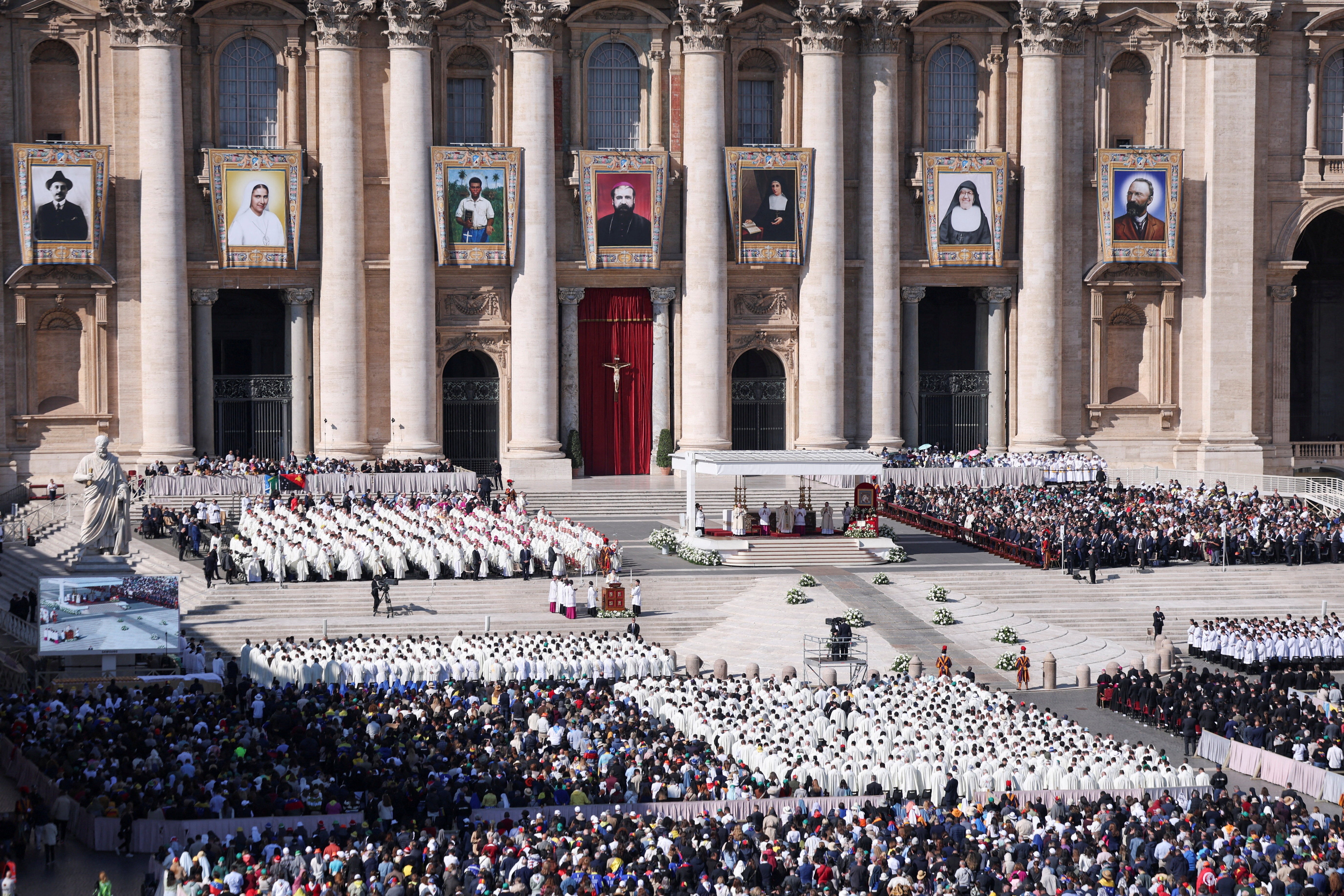 Tens of thousands of people turned out to witness the announcement, with portraits of the saints hanging high