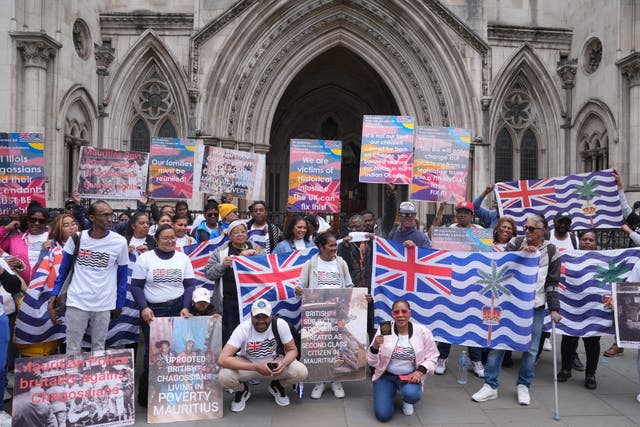 <p>Protesters at the High Court during a hearing over a last-minute block on the Government from concluding its deal on the Chagos Islands (Yui Mok/PA)</p>