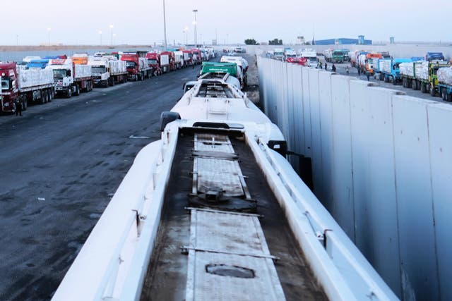 <p>Trucks carrying humanitarian aid prepare to cross the Egyptian gate of the Rafah crossing in October</p>