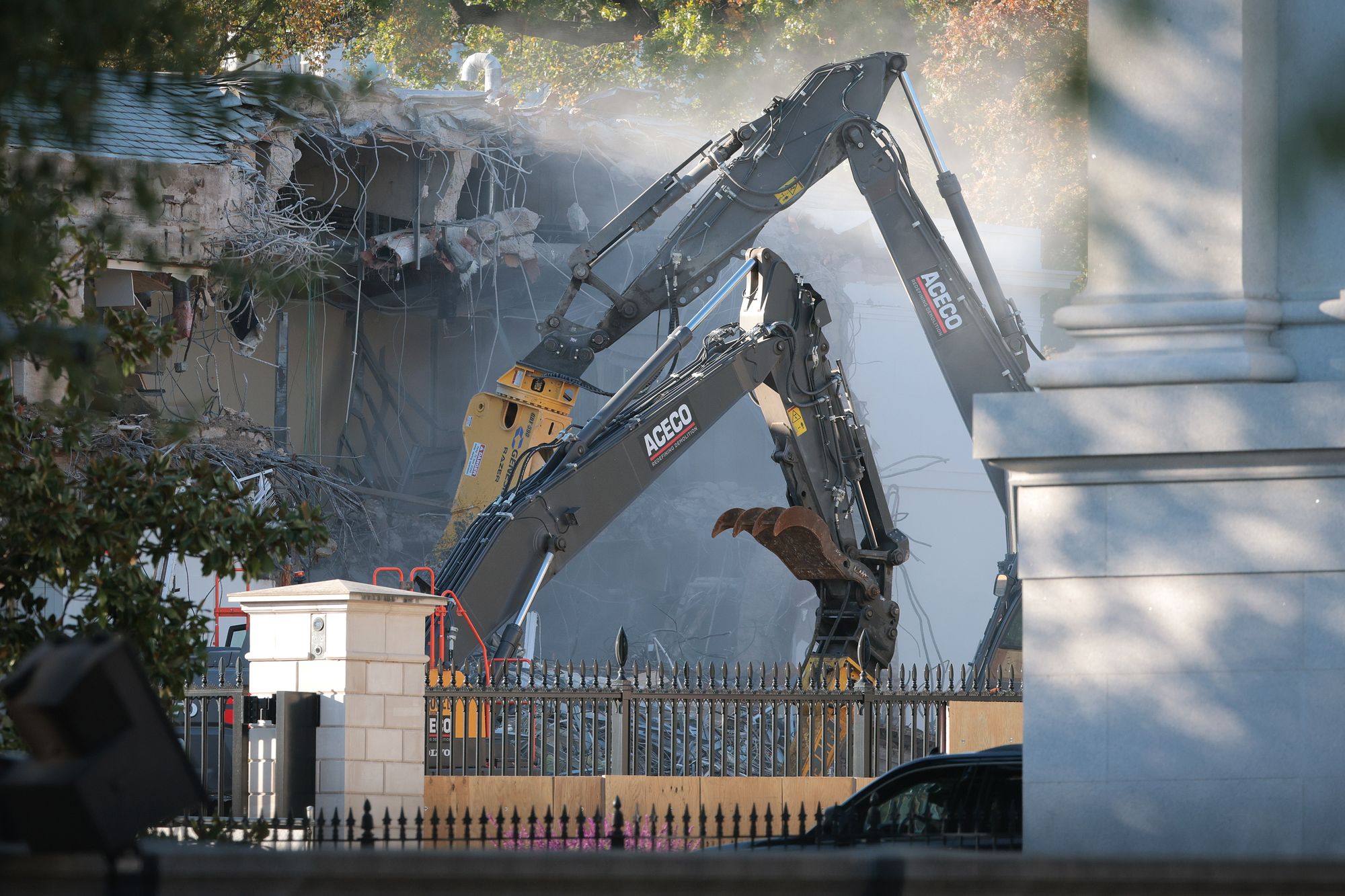Workers demolish the facade of the East Wing of the White House