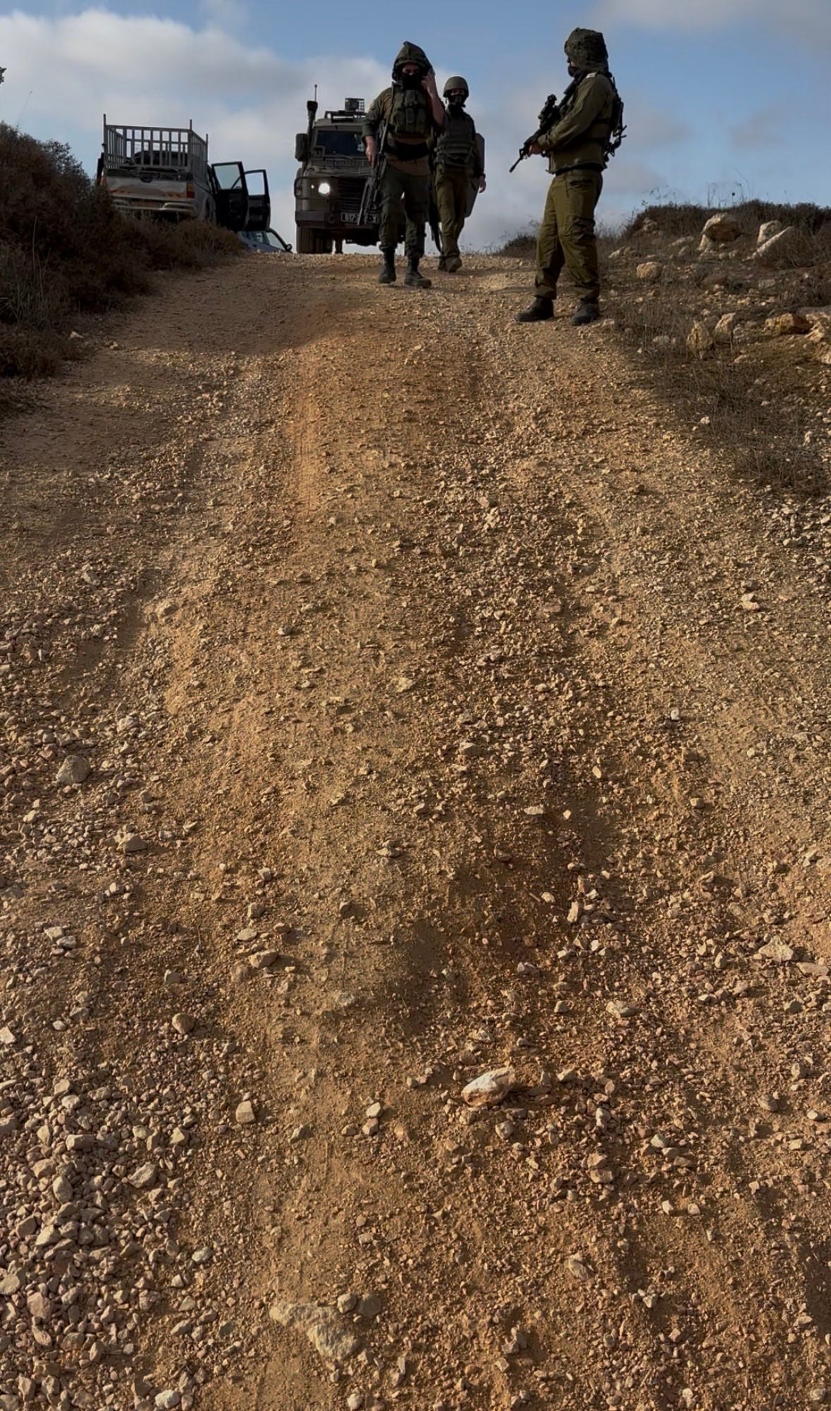 Armed men blocking the road in the West Bank