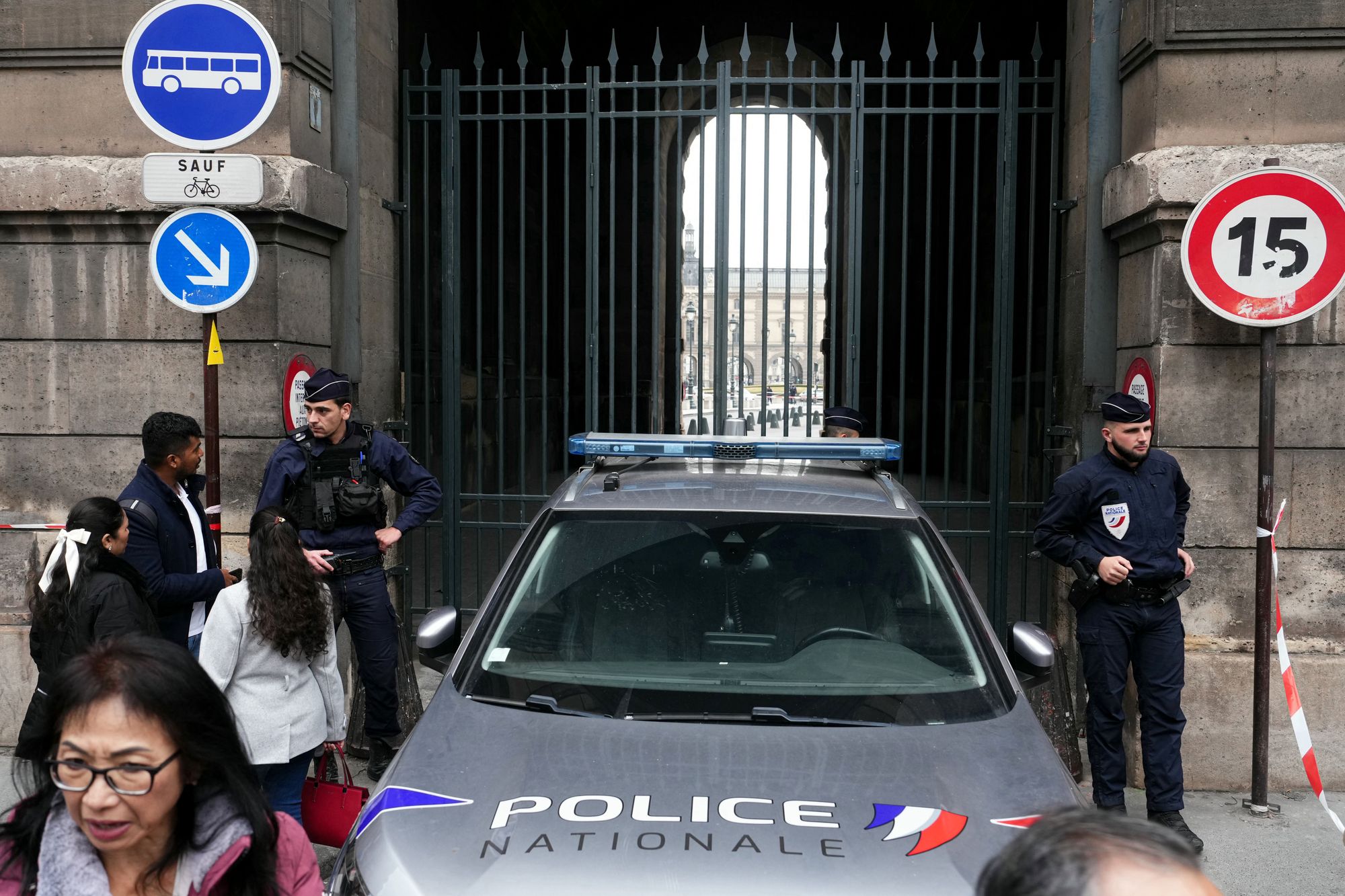 Soldiers patrol as people queue to enter the Louvre museum that remains closed for the day after Sunday's jewels robbery.
