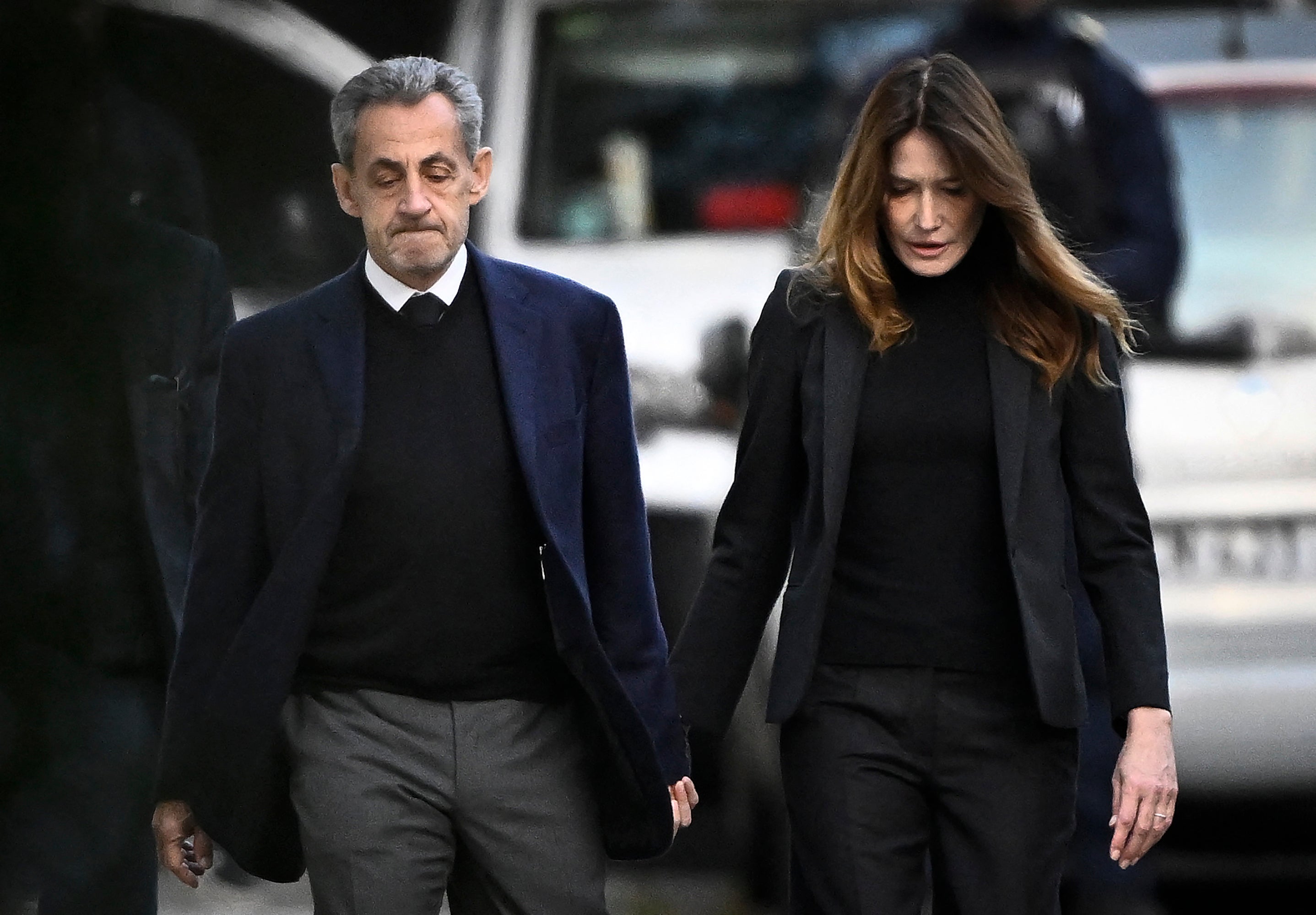 Nicolas Sarkozy, with Carla Bruni-Sarkozy, leaving his home to present himself to La Sante prison