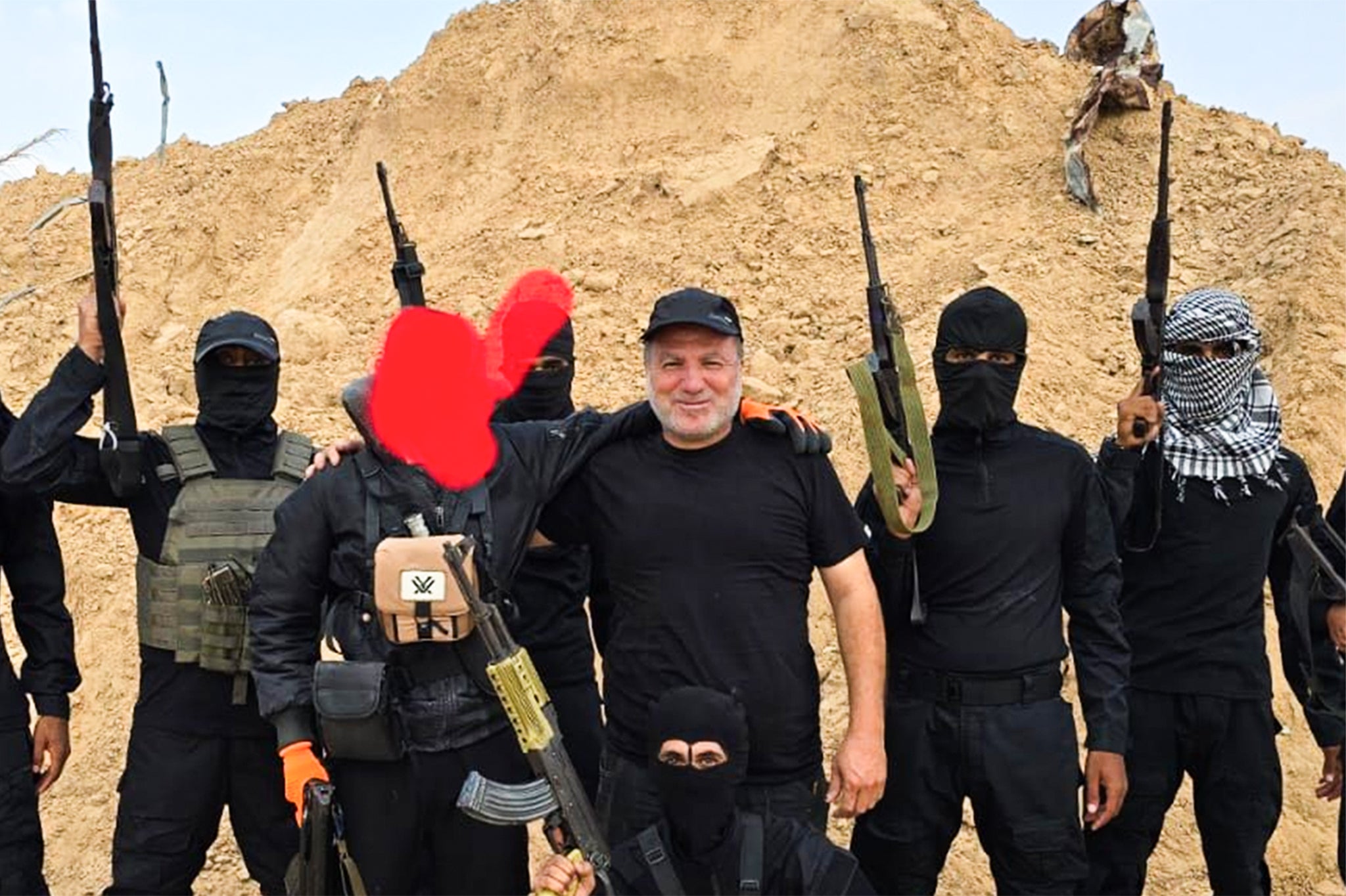 Hossam al-Astal, leader of the anti-Hamas Counter-Terrorism Strike Force, poses with armed militia fighters