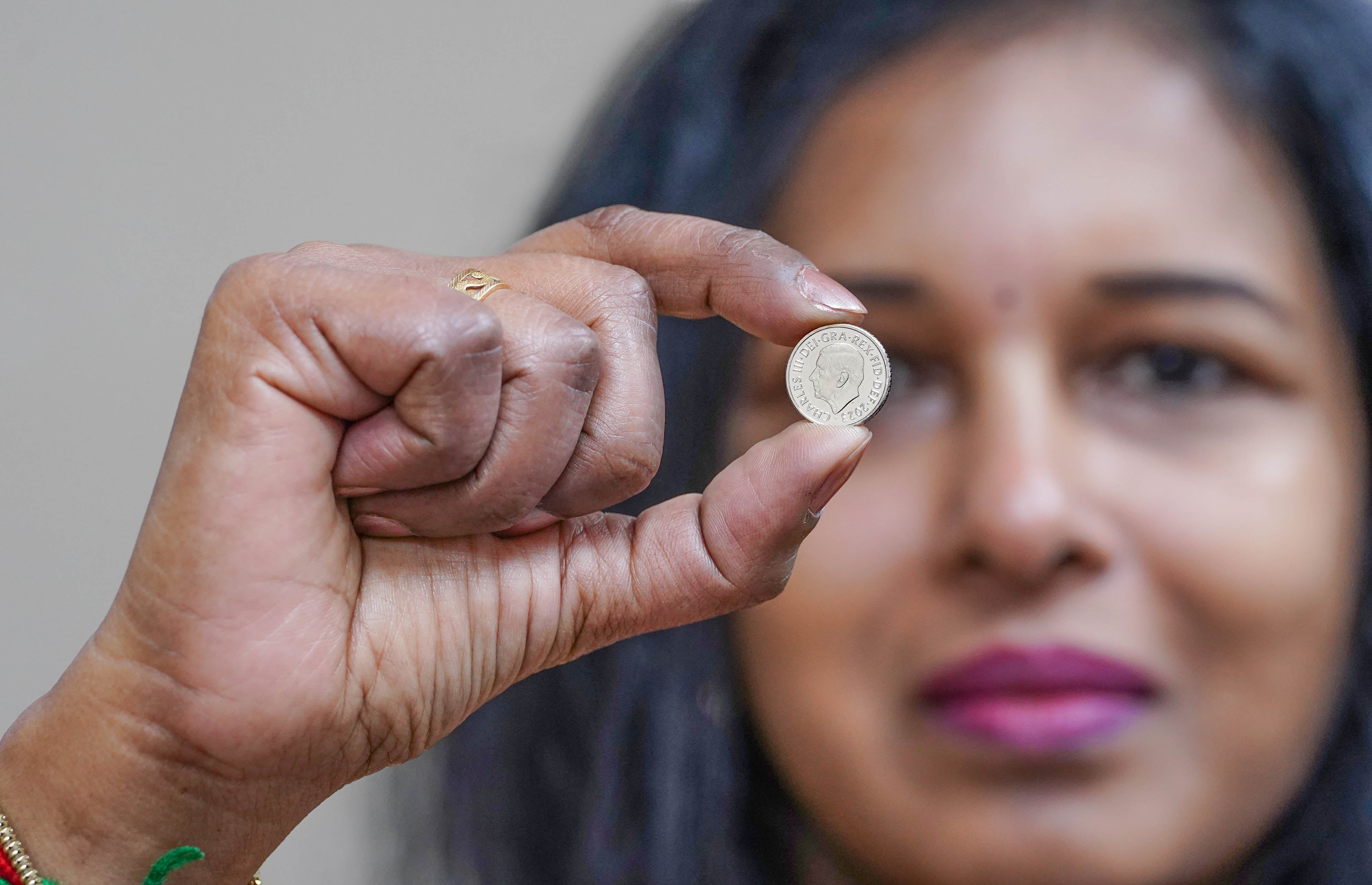 Vasanthi Balachandar, branch manager of Jubilee Oak Post Office, displays the first 5p coins bearing the portrait of King Charles