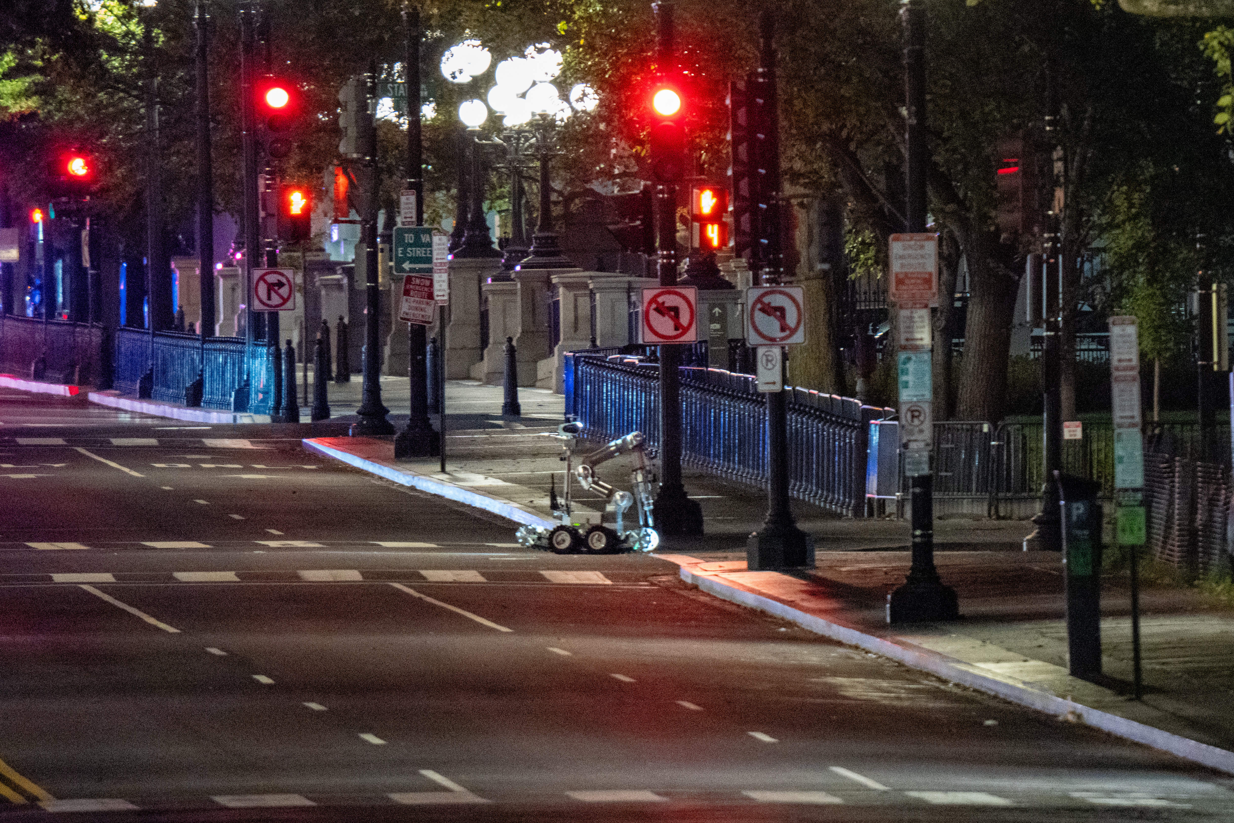 A bomb detection robot inspects the scene after a vehicle rammed a security barricade at the White House complex