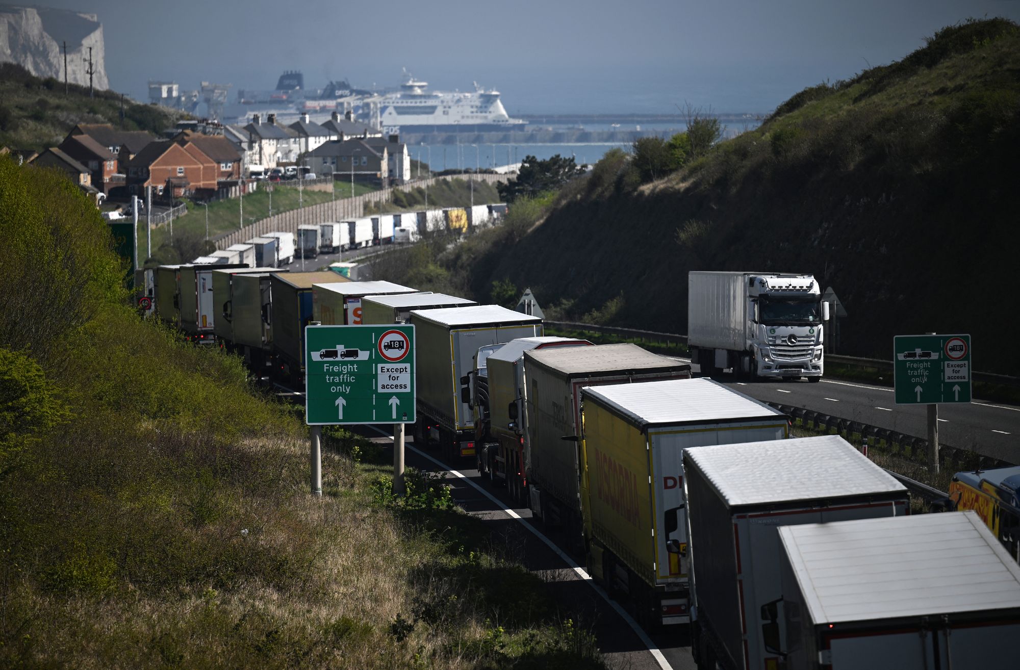 Lorries line up on the A20 road to use the Dover Tap contraflow system into the Eastern Dock of the Port of Dover where the cross channel port is situated with ferries departing here to go to Calais in France