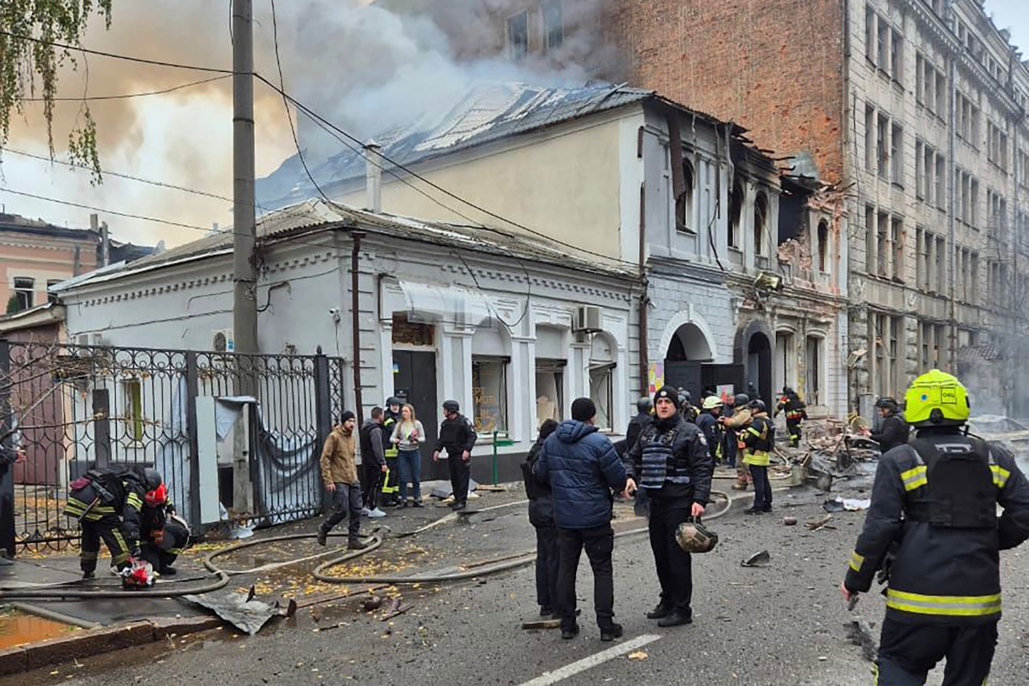 In this handout photograph taken and released by the Ukrainian Emergency Service on October 22, 2025, Ukrainian law enforcement officers work at the site of a drone attack that hit a kindergarten in Kharkiv, amid the Russian invasion of Ukraine