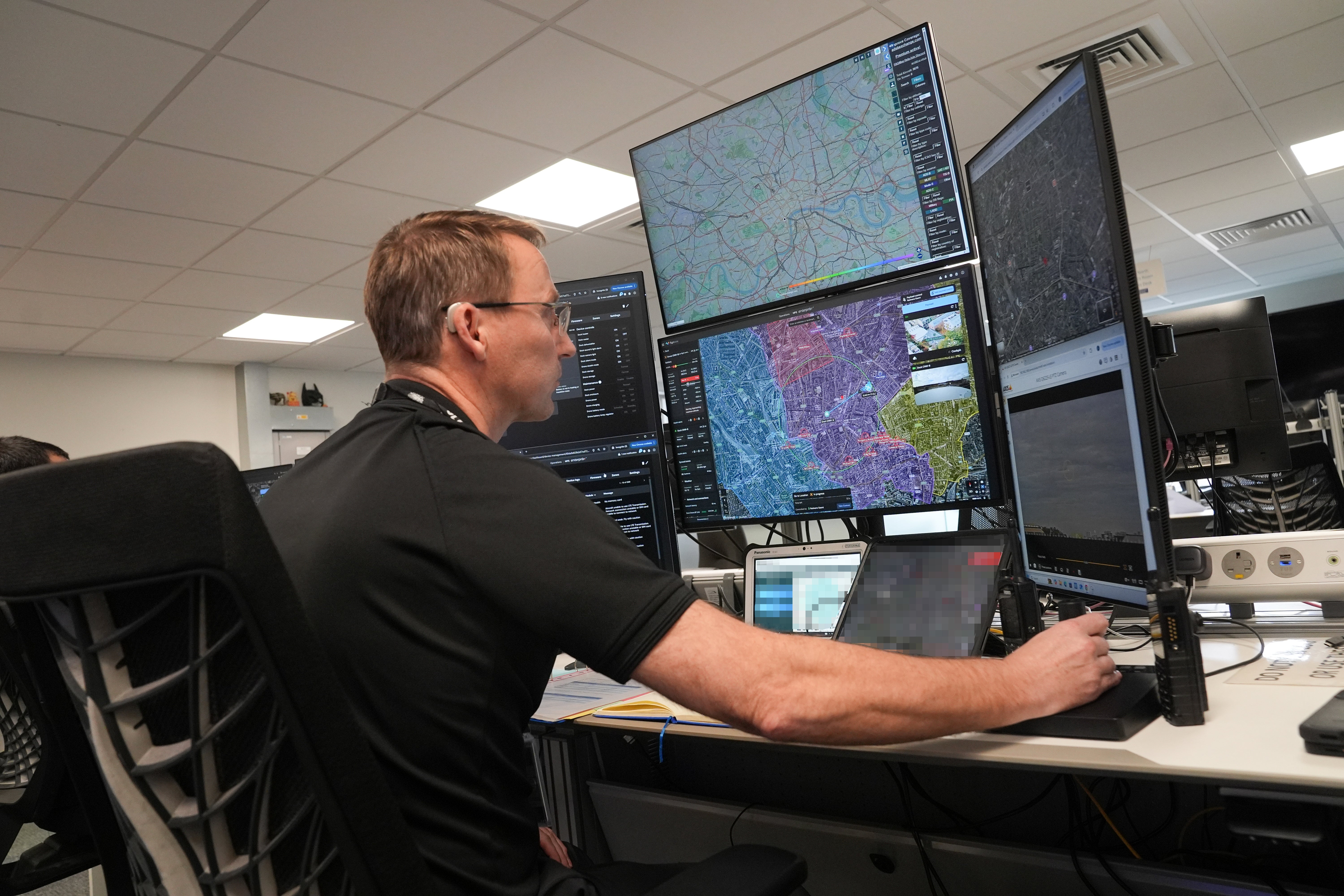 A police officer pilots a drone during a demonstration of the service