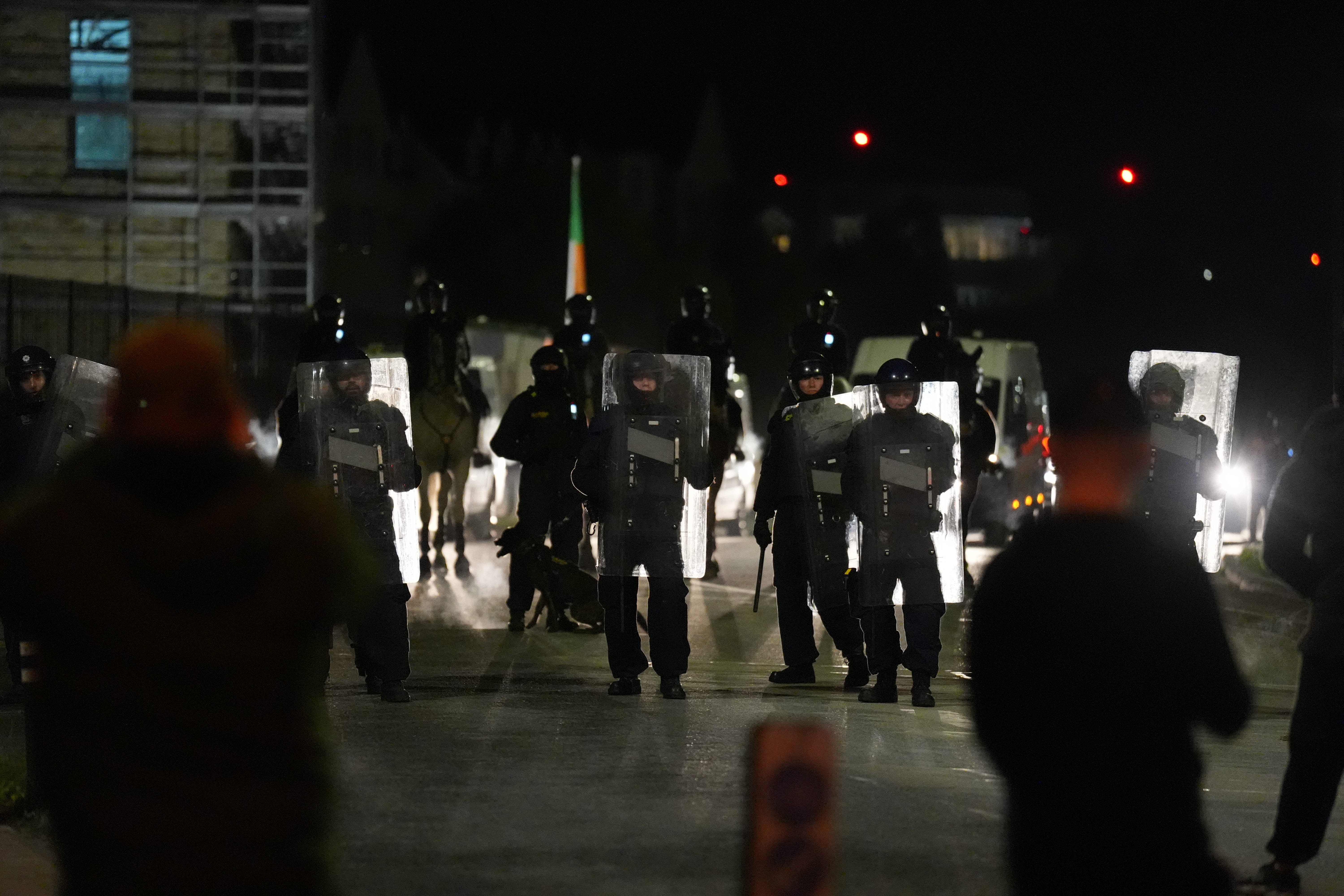 Gardai officers block protesters near the Citywest Hotel, as disturbances have flared outside the Dublin hotel which used to house asylum seekers (Niall Carson/PA)
