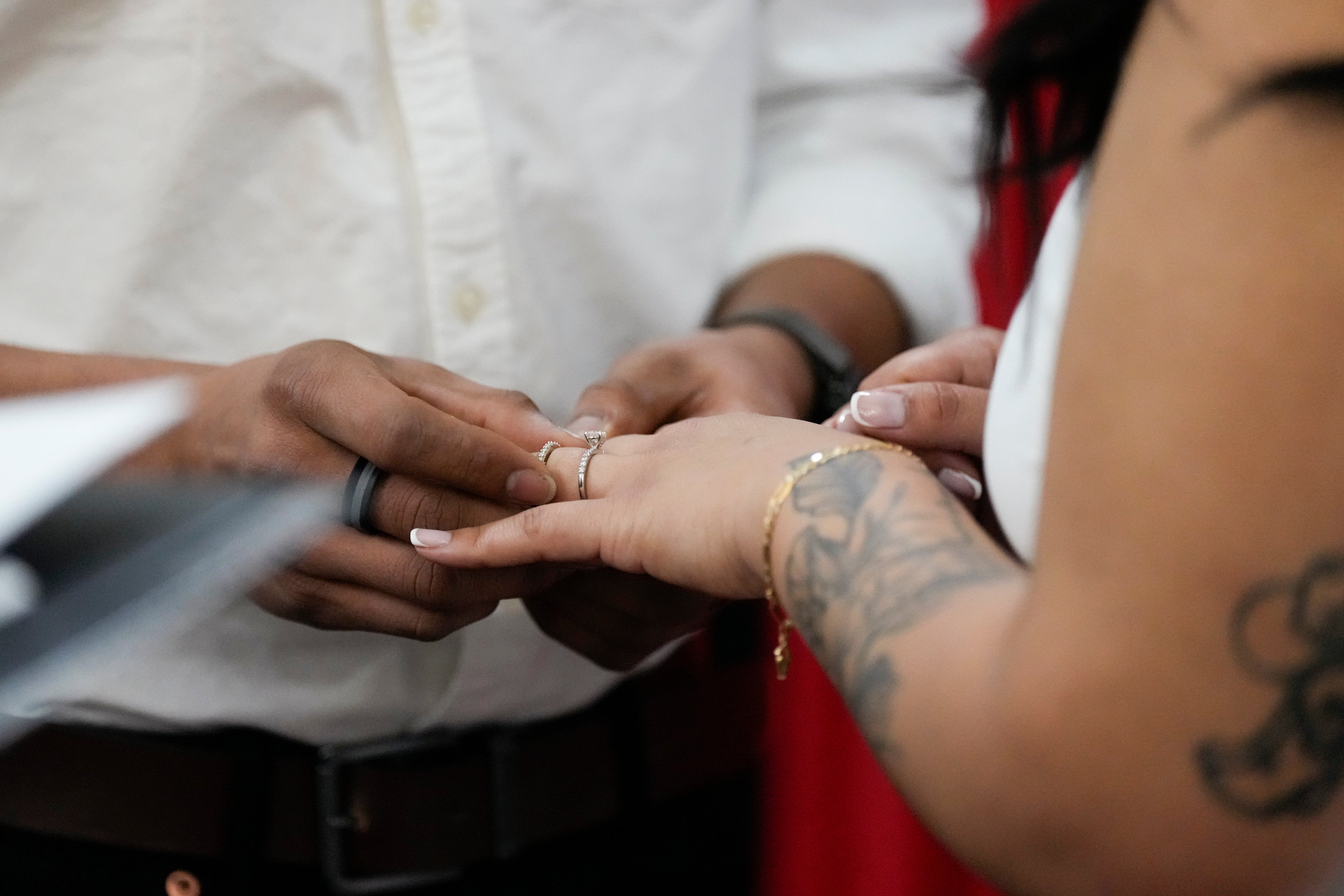 Groom places ring on bride’s finger