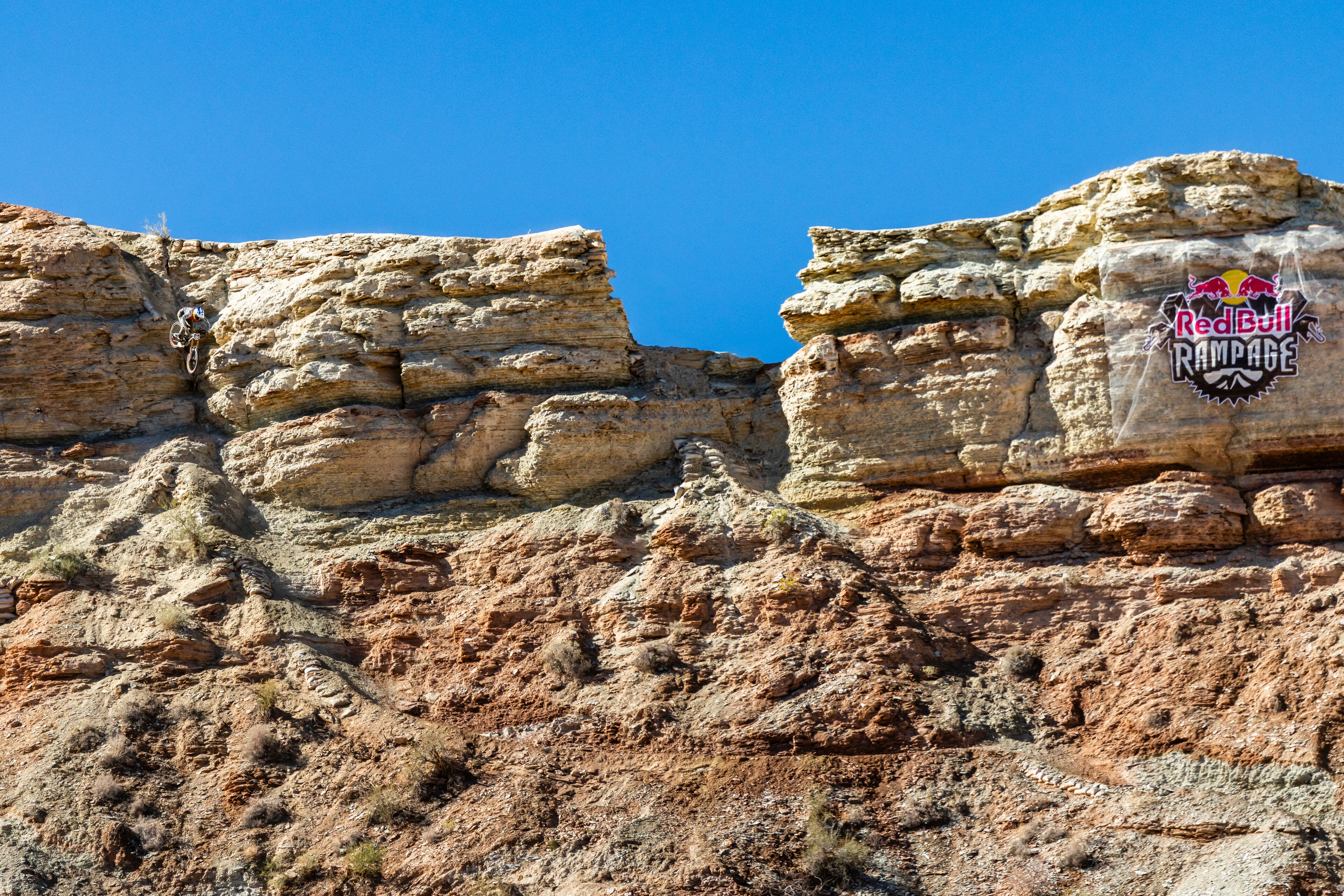Third-place finisher Georgia Astle rides down the course; to the right is the infamous 'Battleship' rock feature