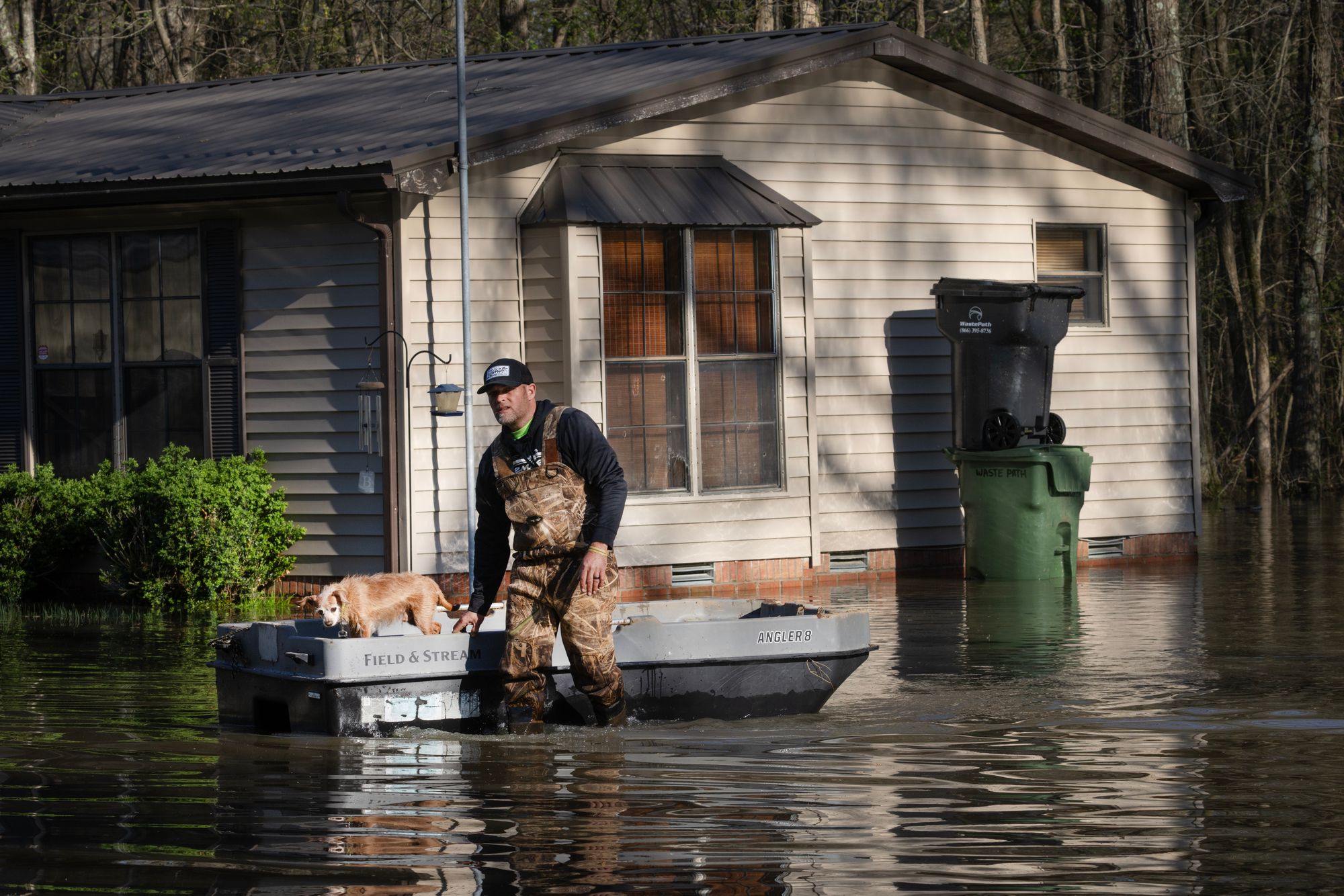 A man wades through floodwater with his dog outside his home Paducah, Kentucky, this past April. Severe storms caused major flooding in the state and throughout the central U.S. in the winter and spring
