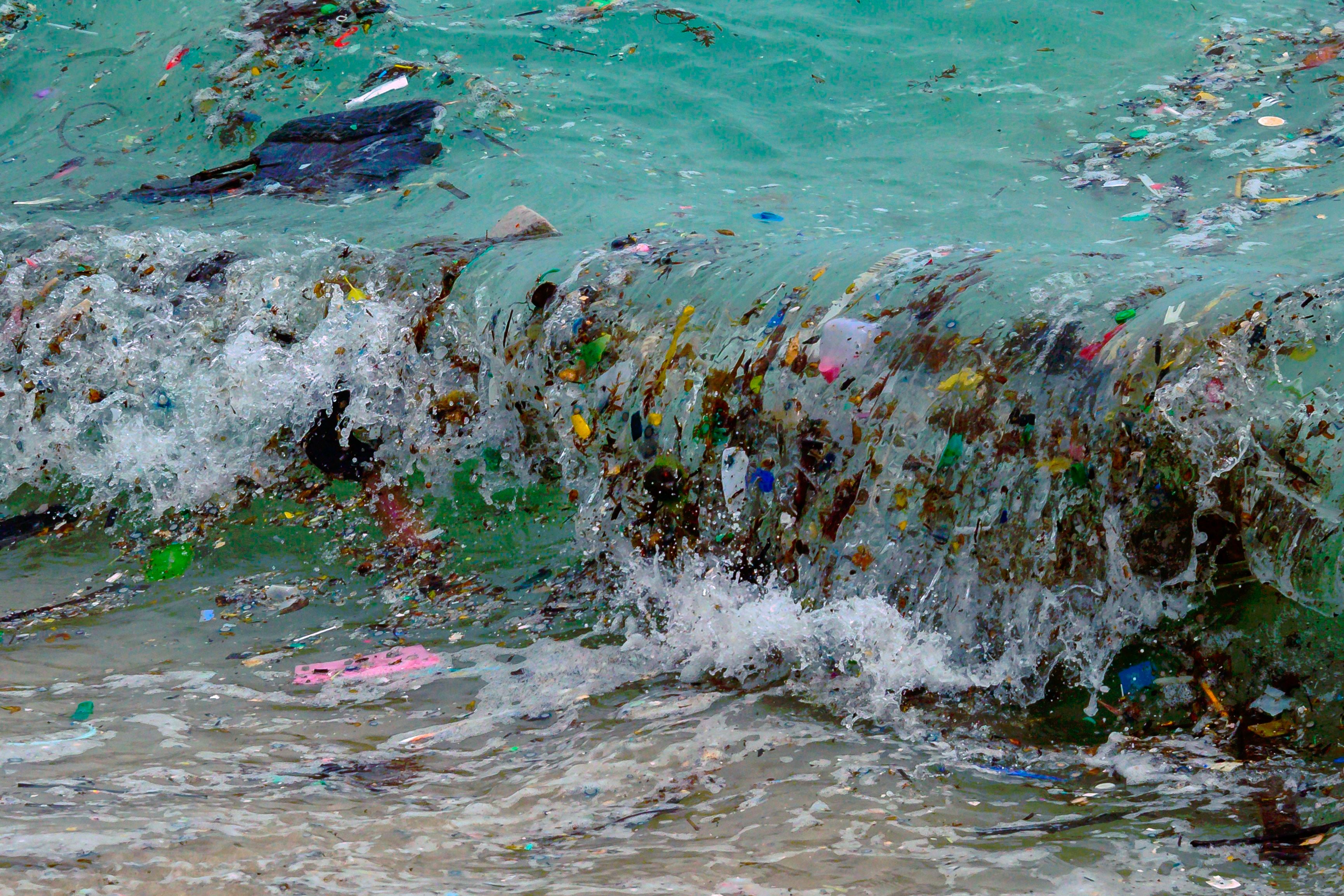A wave carrying plastic waste and other rubbish washes up on a beach in the Gulf of Thailand in January 2021. Plastic in the oceans is harming both animal and human health