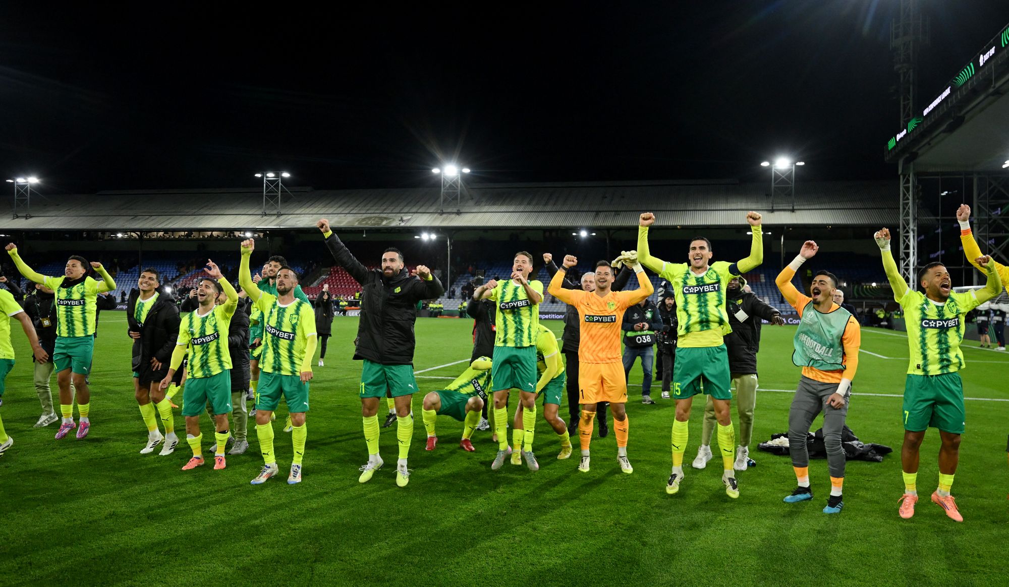 <p>AEK Larnaca players celebrating their victory in front of the away fans</p>