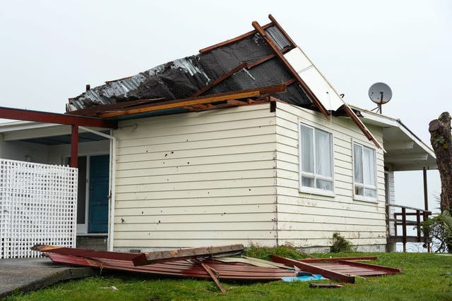 <p>A suburban house sees its roof peeled during a rare red wind warning in Wellington, New Zealand</p>