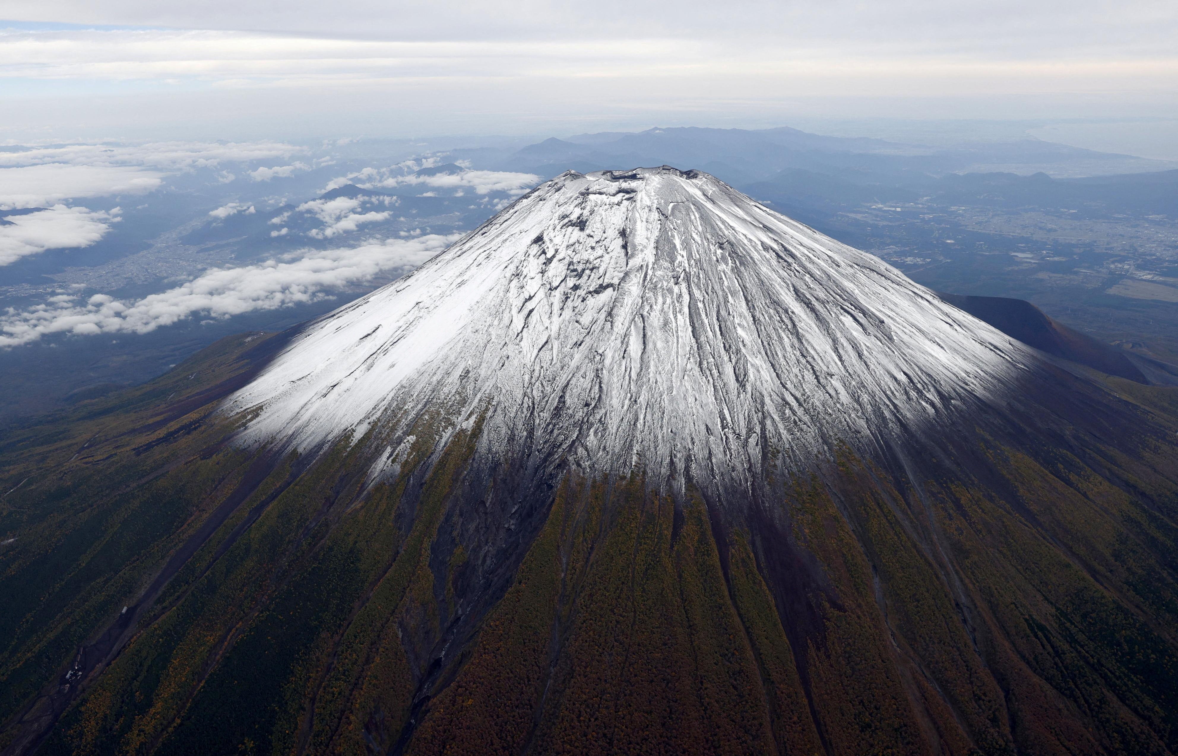 <p>Photo taken from a helicopter shows the season’s first snowcap on Mount Fuji, Japan’s highest mountain, on 23 October 2025</p>