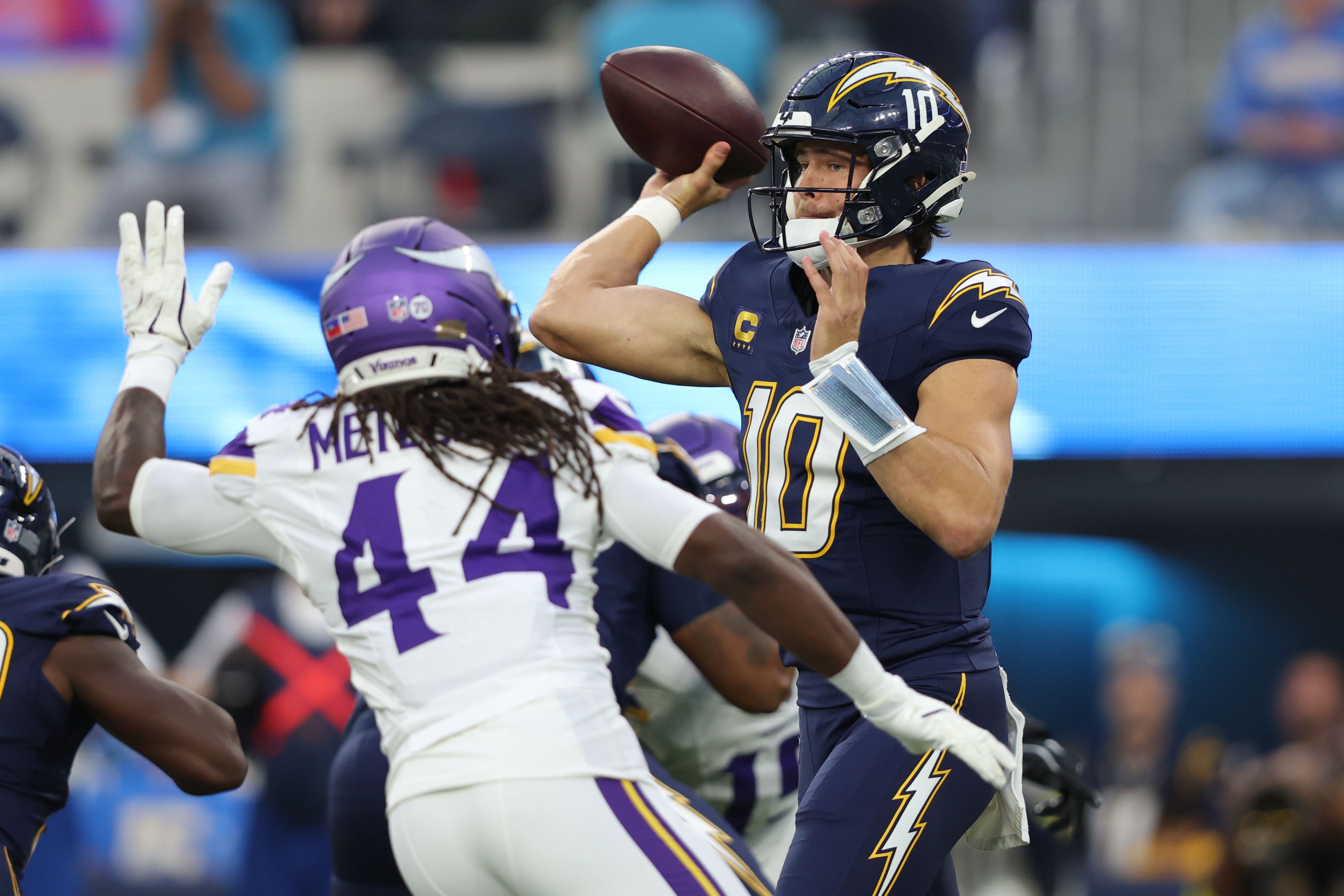 Los Angeles Chargers quarterback Justin Herbert passes over Minnesota Vikings safety Josh Metellus (Jessie Alcheh/AP)