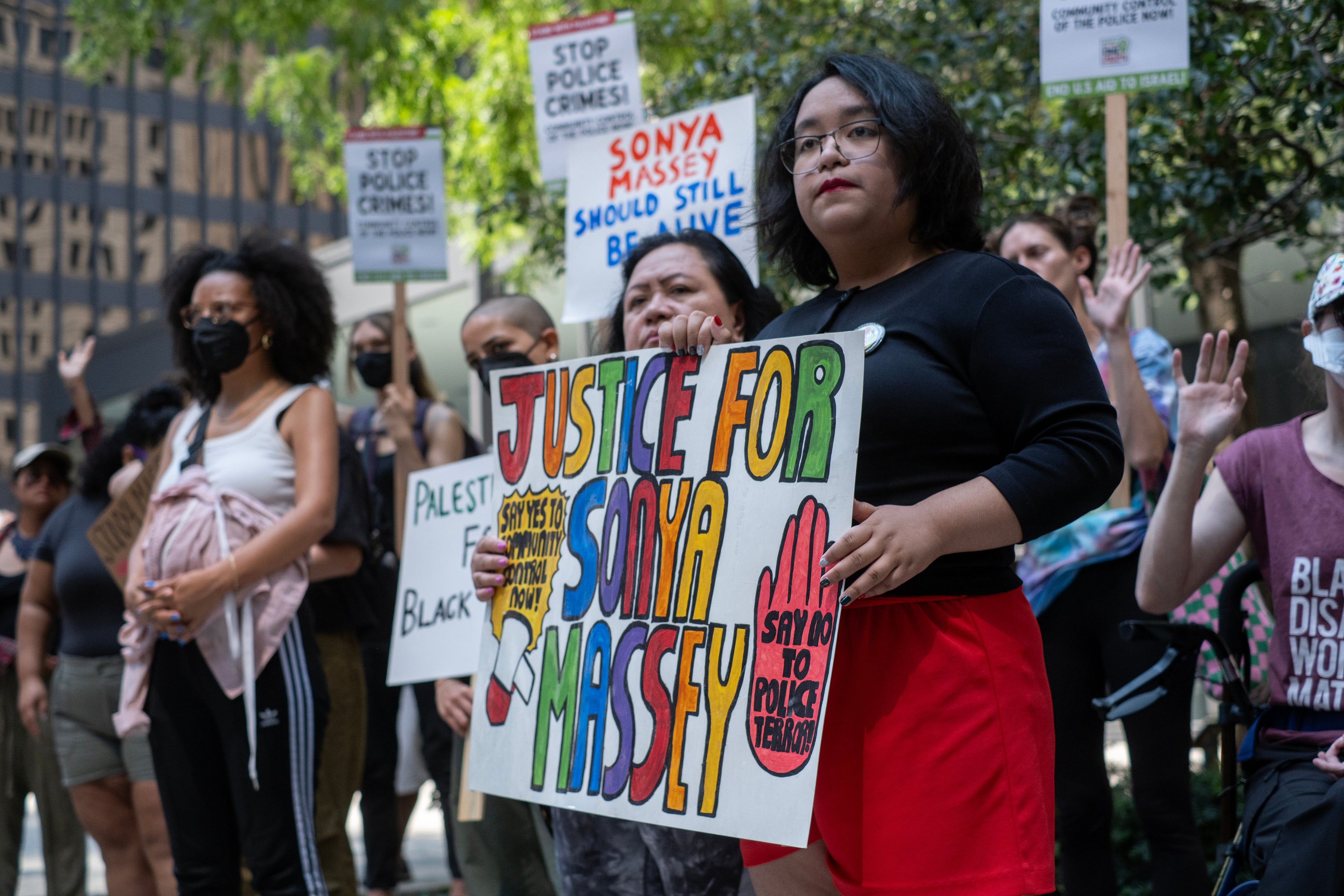 Demonstrators in Chicago, Illinois, gathered with signs to protest the killing of Sonya Massey in July 2024. Illinois Governor JB Pritzker signed "Sonya Massey's Bill" into law in August, which seeks to 'promote policy accountability' and 'prevent future tragedies such as the killing of Sonya Massey.'