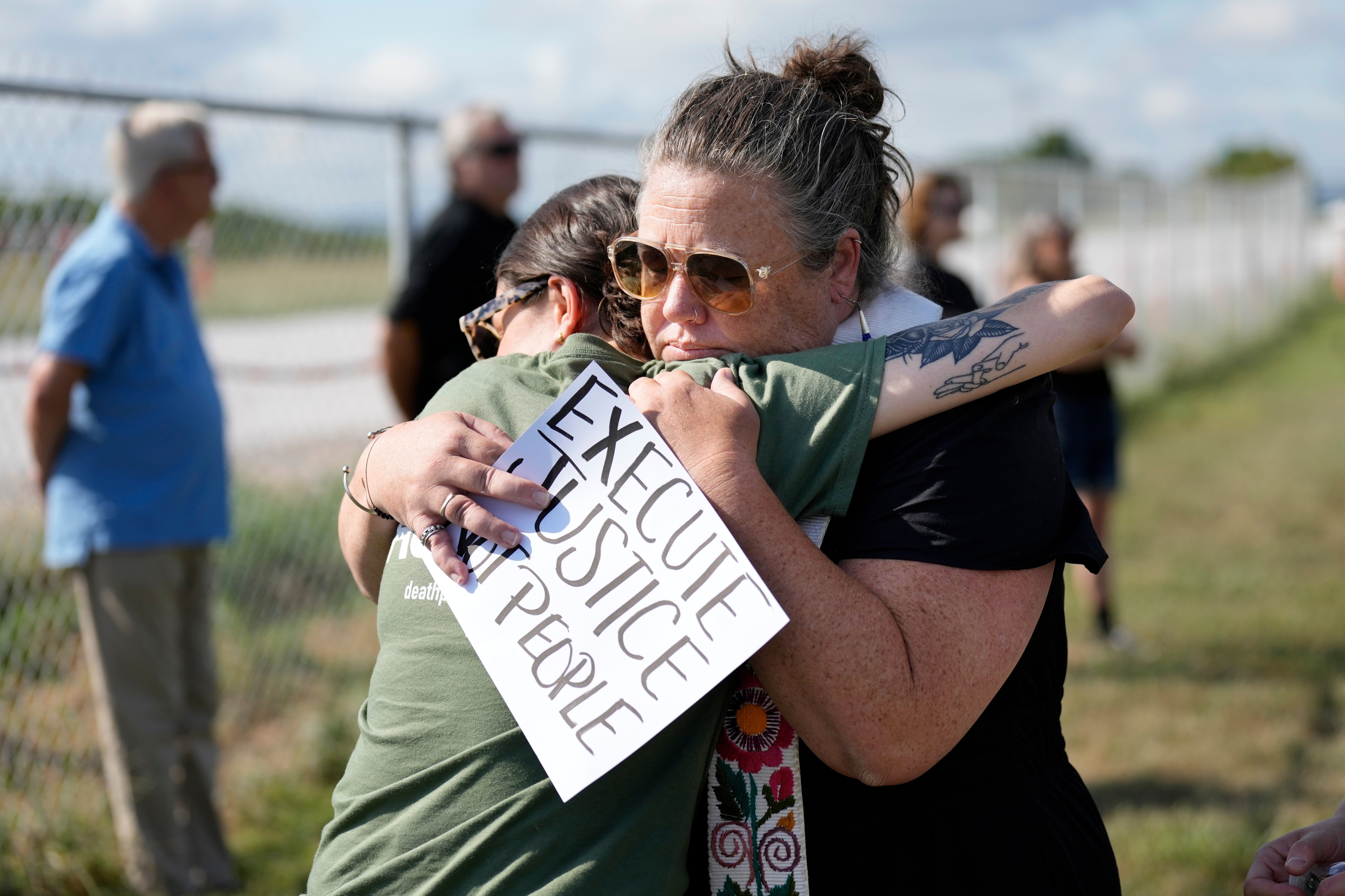 India Pungarcher, left, hugs Rev. Ingrid McIntyre as demonstrators gather in the area reserved for anti-death penalty protesters outside Riverbend Maximum Security Institution before the execution of Byron Black in Nashville, Tenn., on Tuesday, Aug. 5, 2025. (AP Photo/Mark Humphrey, File)