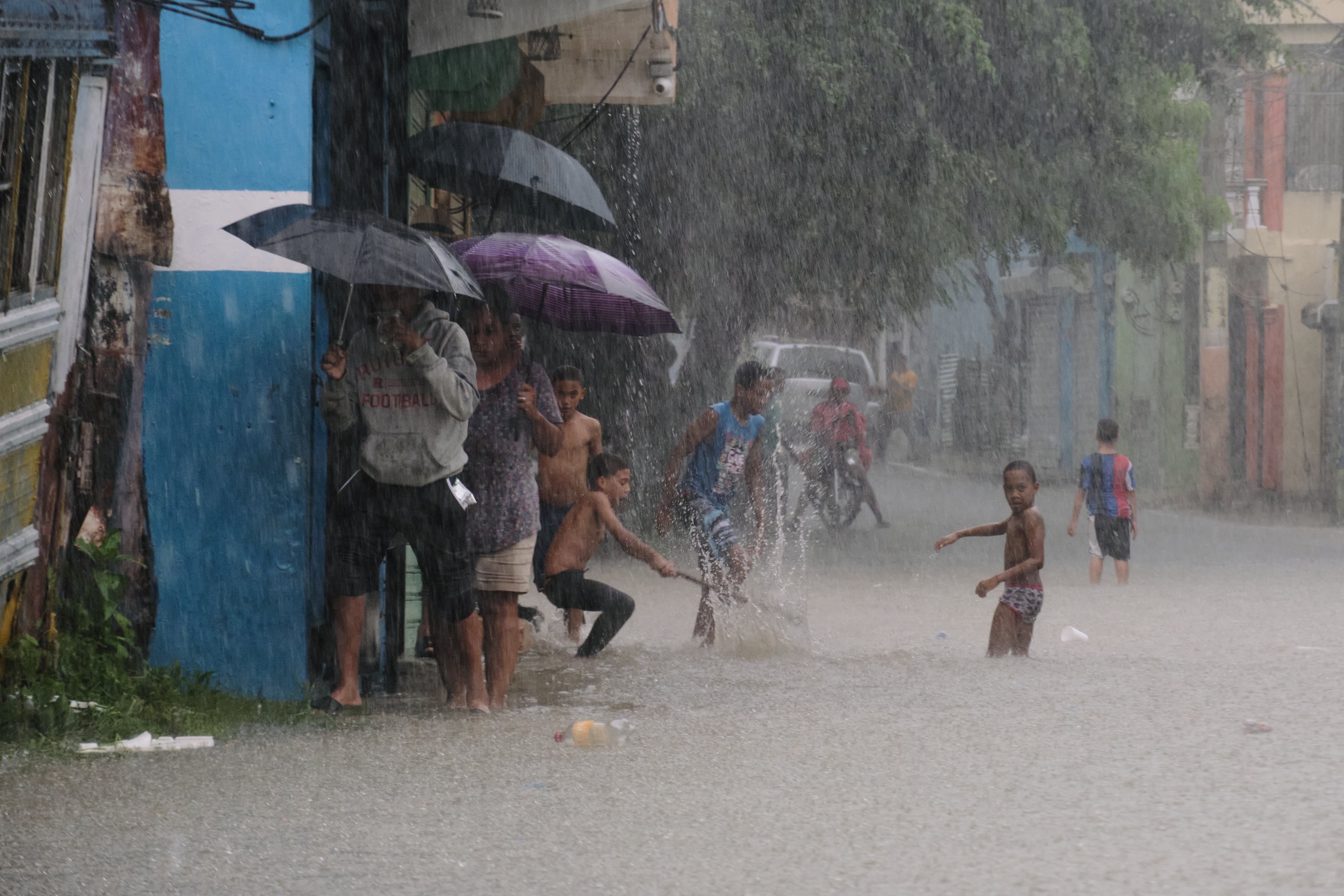 Children play in a street flooded by rains caused by Tropical Storm Melissa in Santo Domingo, Dominican Republic, Friday, Oct. 24, 2025. (AP Photo/Ricardo Hernandez)
