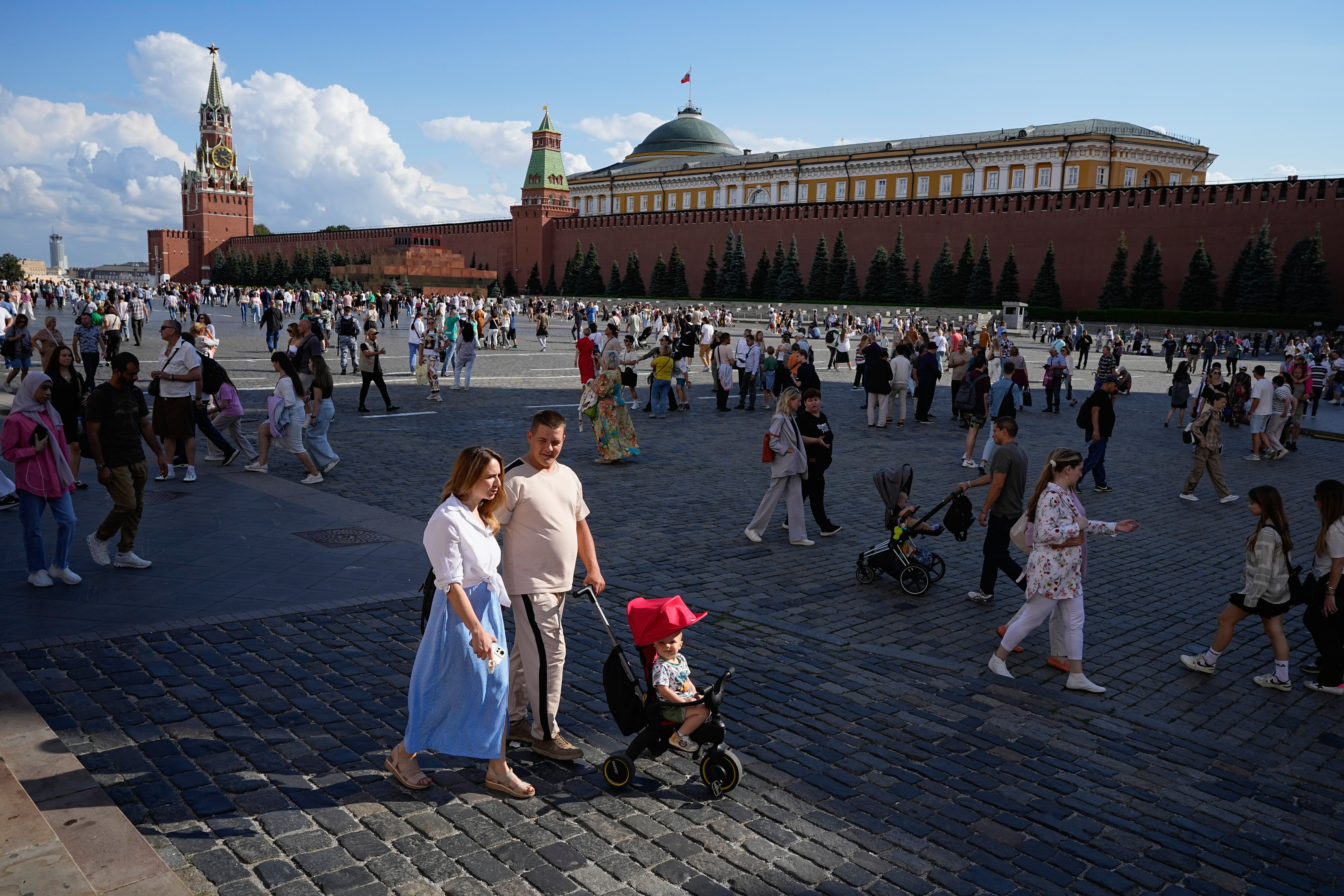 A family walks through Red Square in Moscow. The fertility rate last year in Russia was 1.4 children per woman – well below the replacement rate