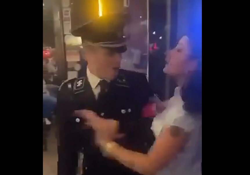 Kenneth Morgan, 33, left, wearing a Nazi uniform and yelling at a woman who is trying to keep him from entering Cutter's Pub in Athens, Georgia