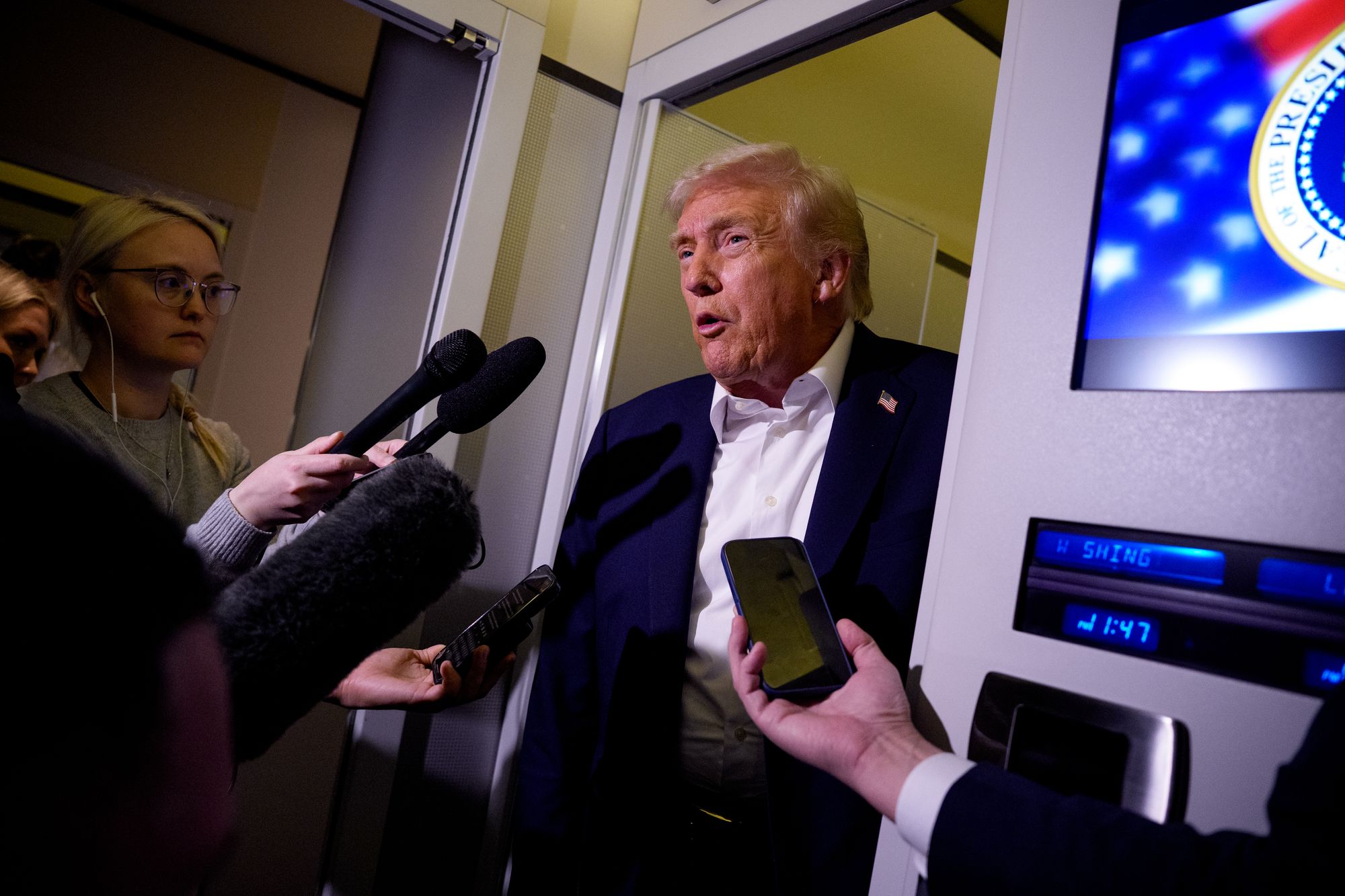 President Donald Trump speaks to members of the media aboard Air Force One on October 24, 2025, in flight