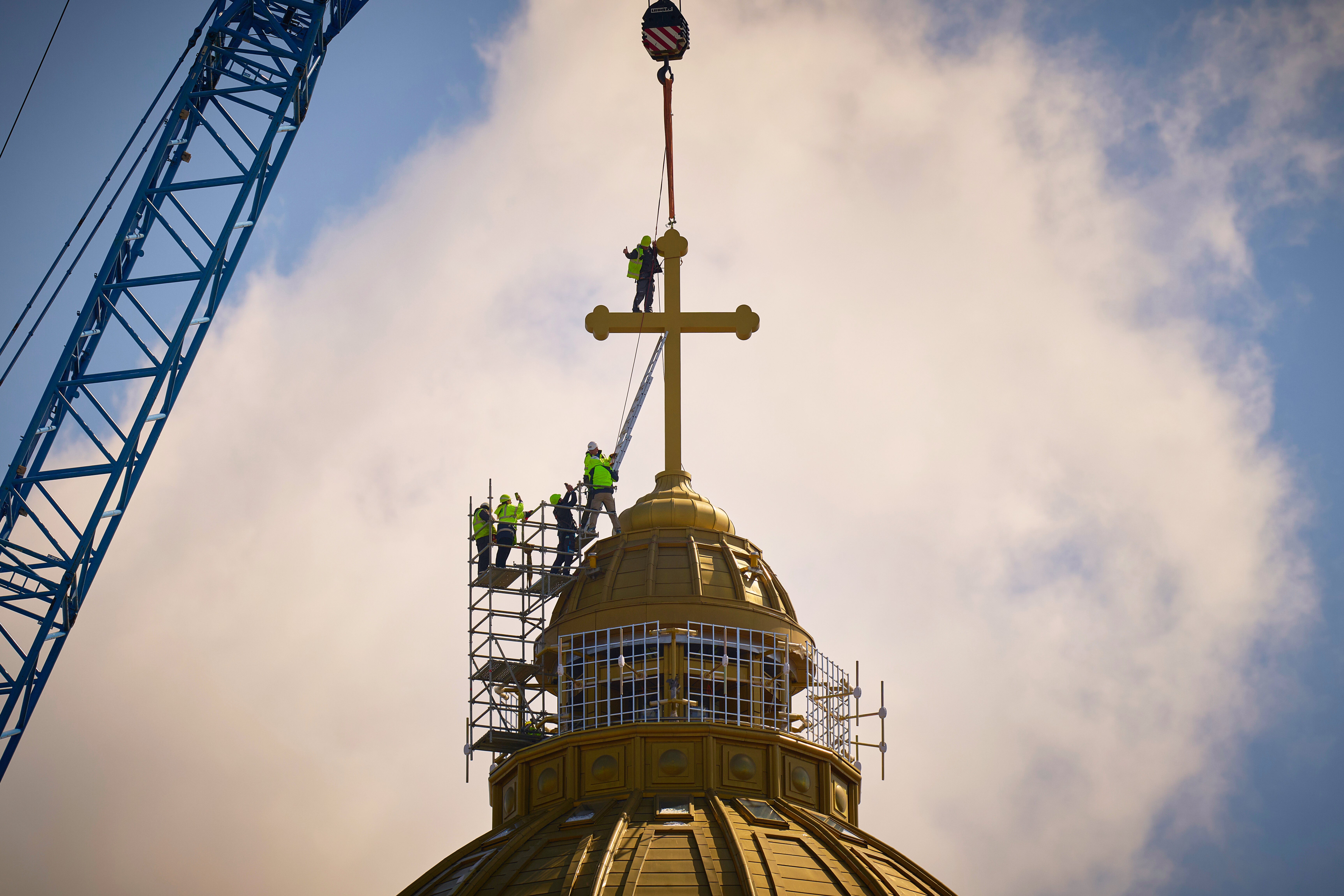 A construction worker gives a thumbs up in the final stages of installation for the main cross of the National Cathedral, in Bucharest, Romania, Tuesday, April 8, 2025. (AP Photo/Vadim Ghirda, File)