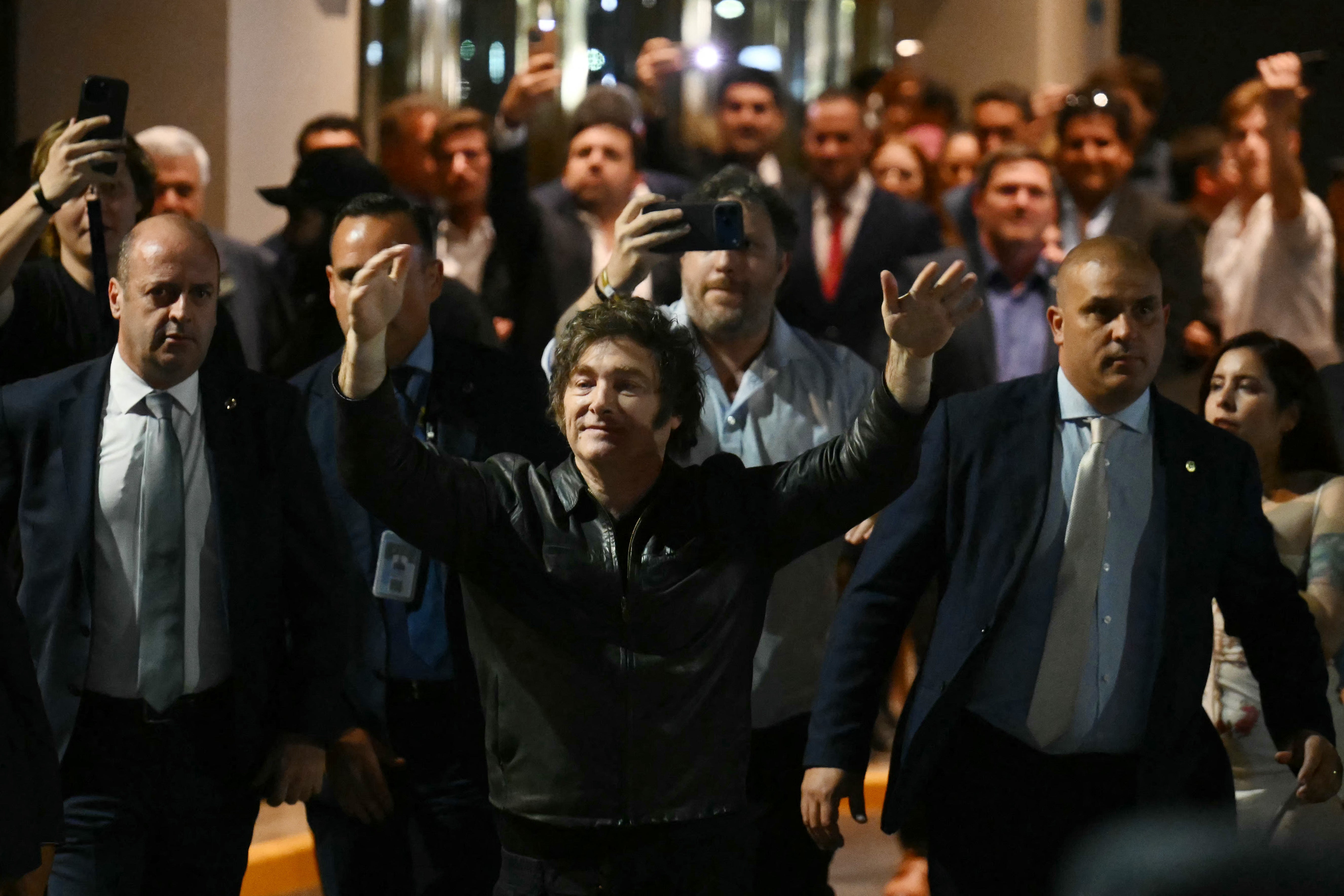 Argentina's President Javier Milei (C) celebrates in front of supporters outside the ruling party's La Libertad Avanza headquarters after the results of the national midterm legislative election in Buenos Aires