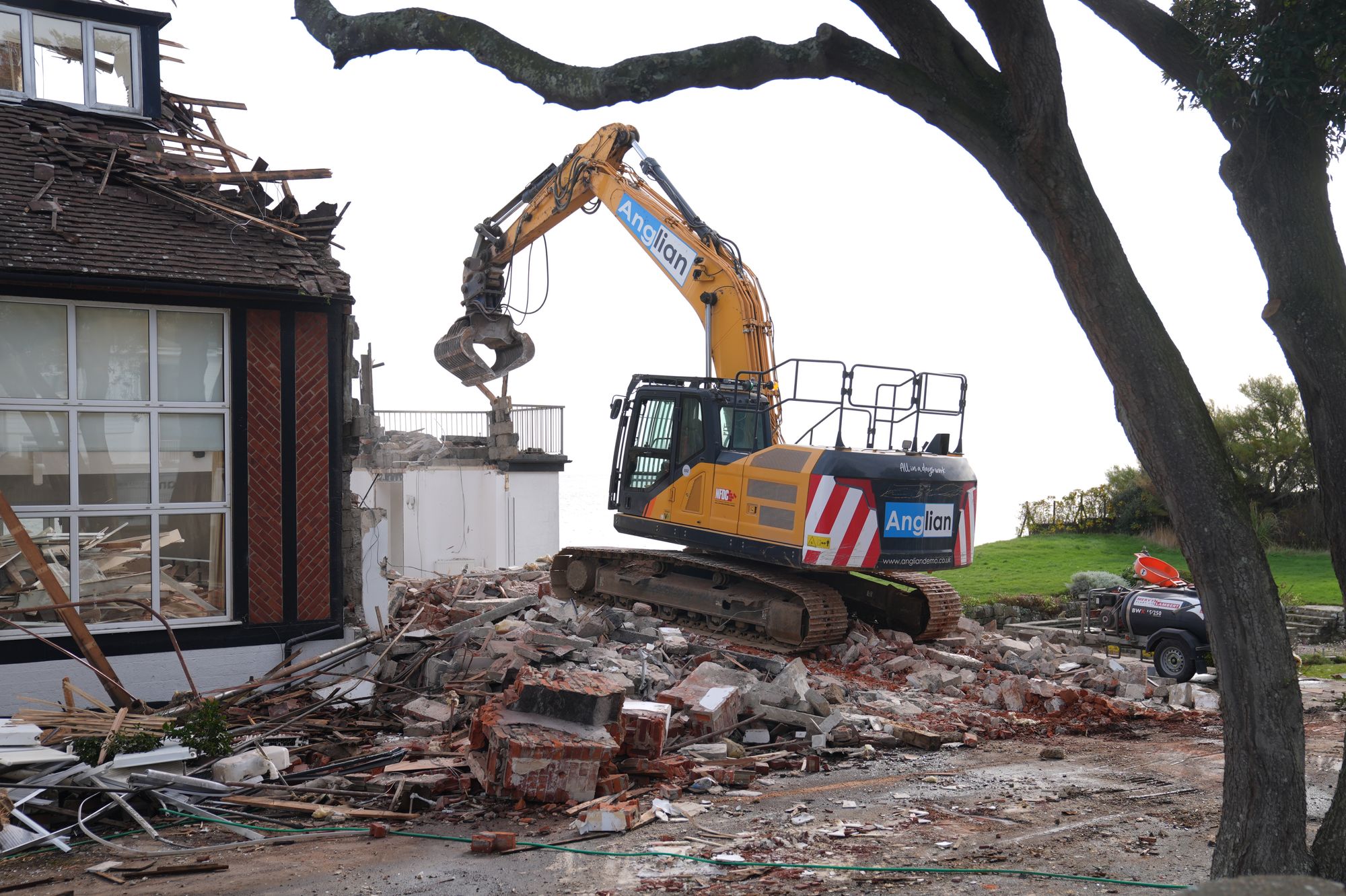 Demolition begins on Jean Flick's clifftop home in Thorpeness, Suffolk