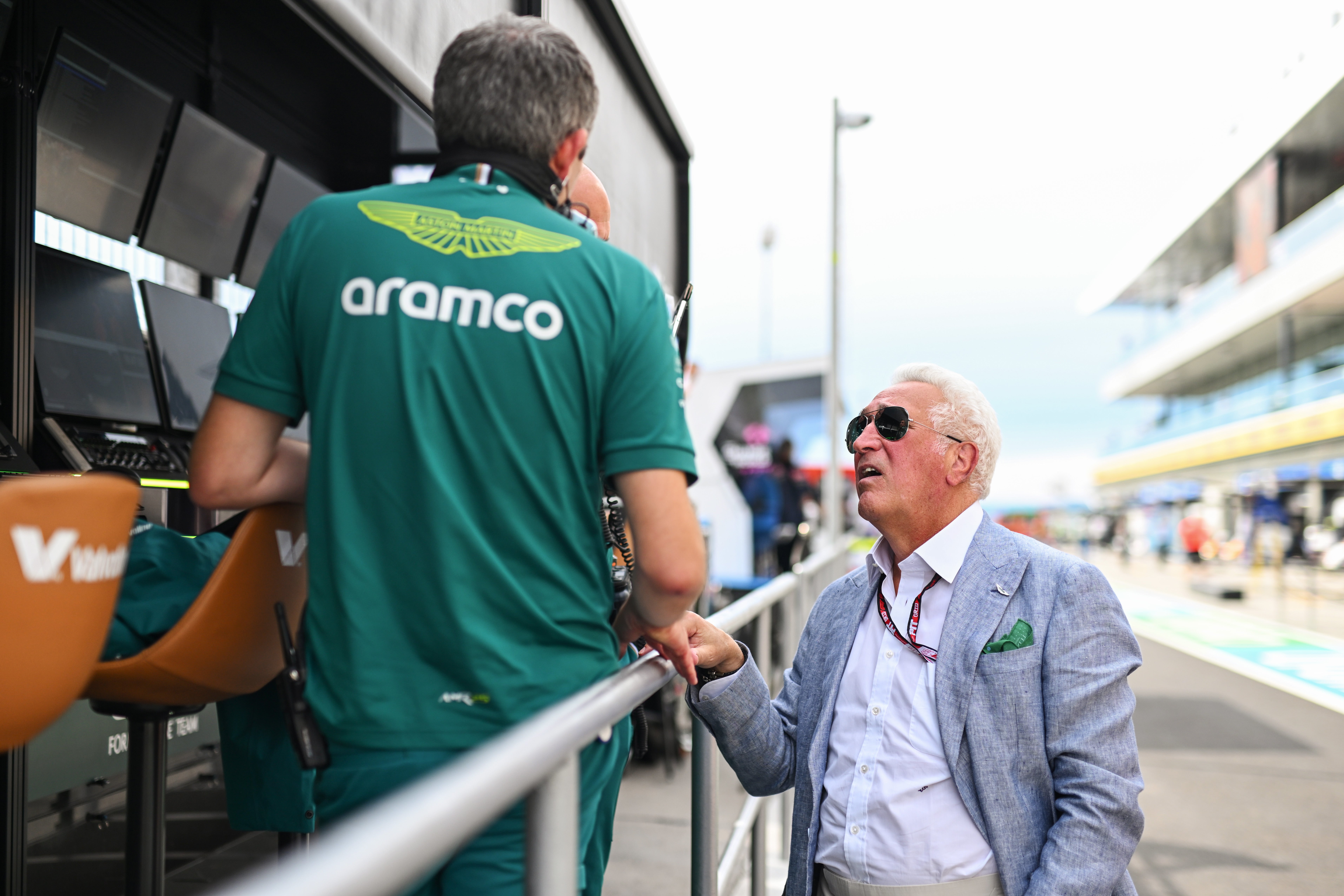 Aston Martin (owned by Lawrence Stroll, right) committed a procedural breach of the 2024 cost cap
