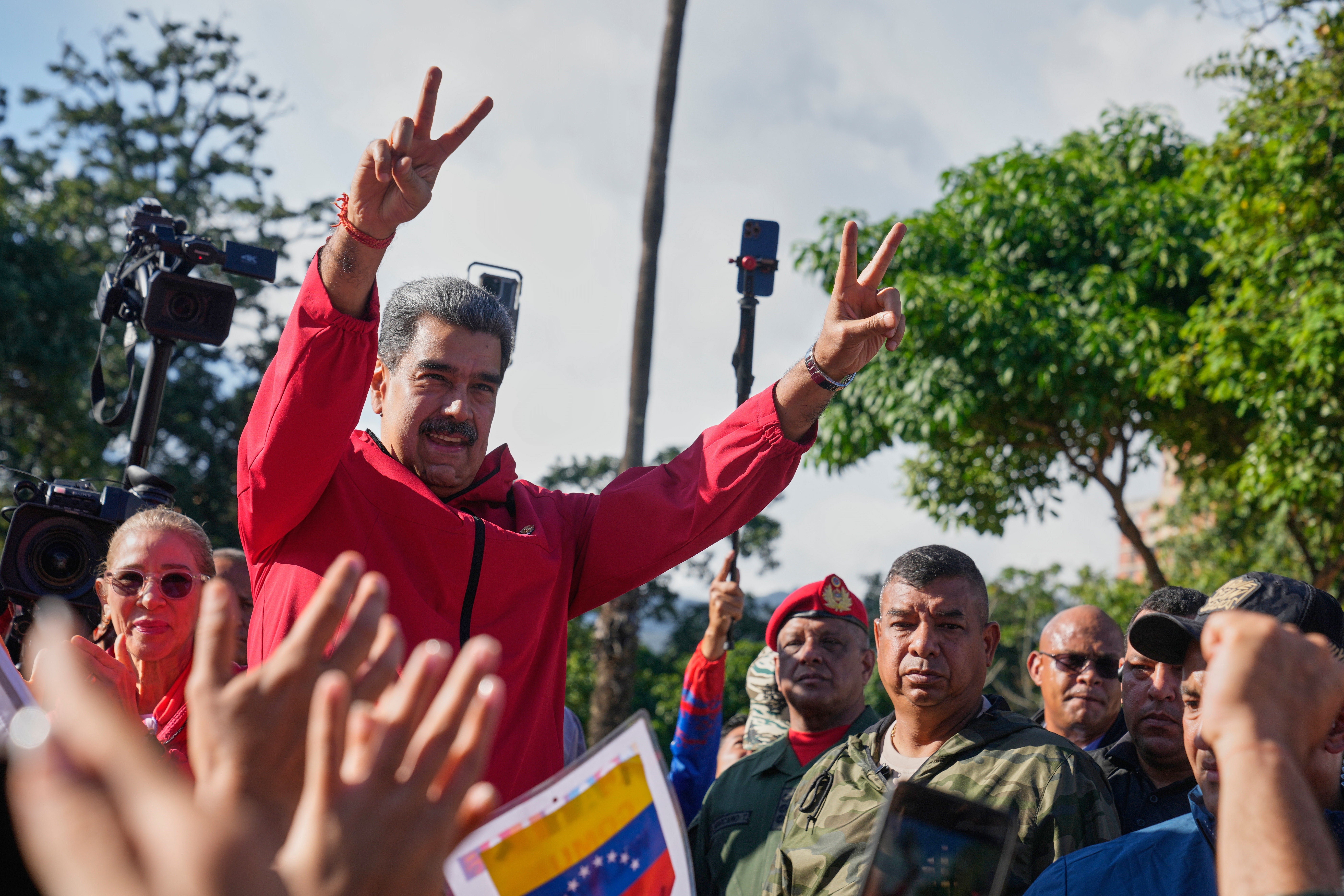President Nicolas Maduro flashes victory signs during Indigenous Day in Caracas, Venezuela, Oct 12, 2025. (AP Photo/Ariana Cubillos, File)