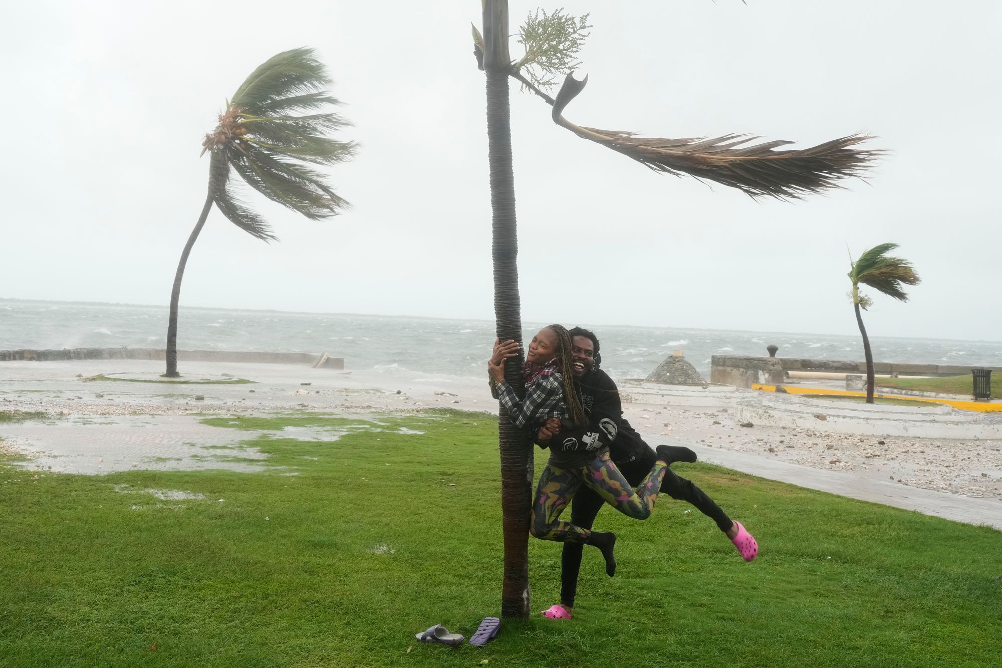 A couple jokes around on the coast in Kingston, Jamaica, as Hurricane Melissa approaches on Tuesday