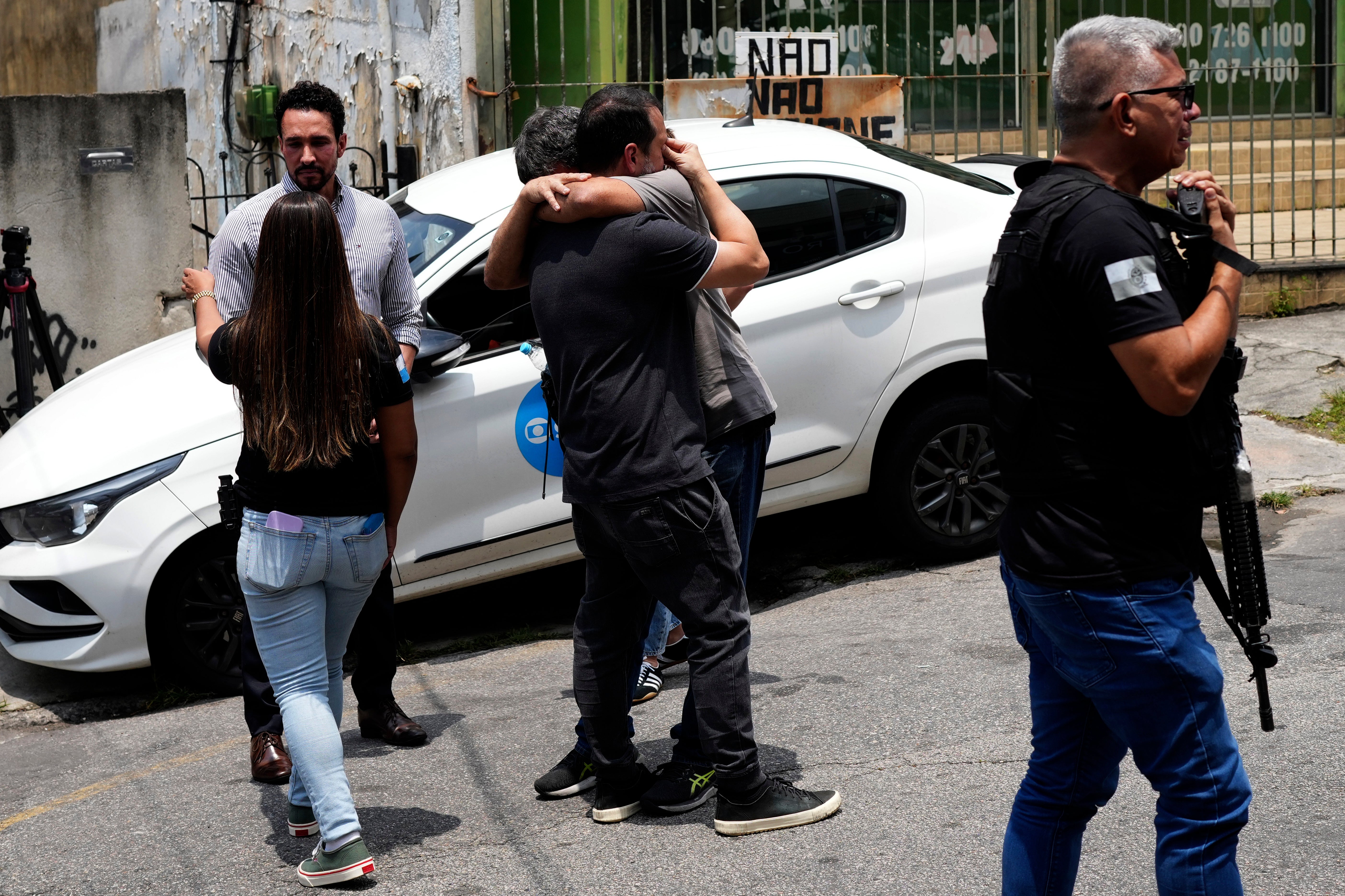 Police gather outside the Getulio Vargas Hospital Tuesday after 60 people were killed during a raid on a notorious gang in Rio de Janeiro