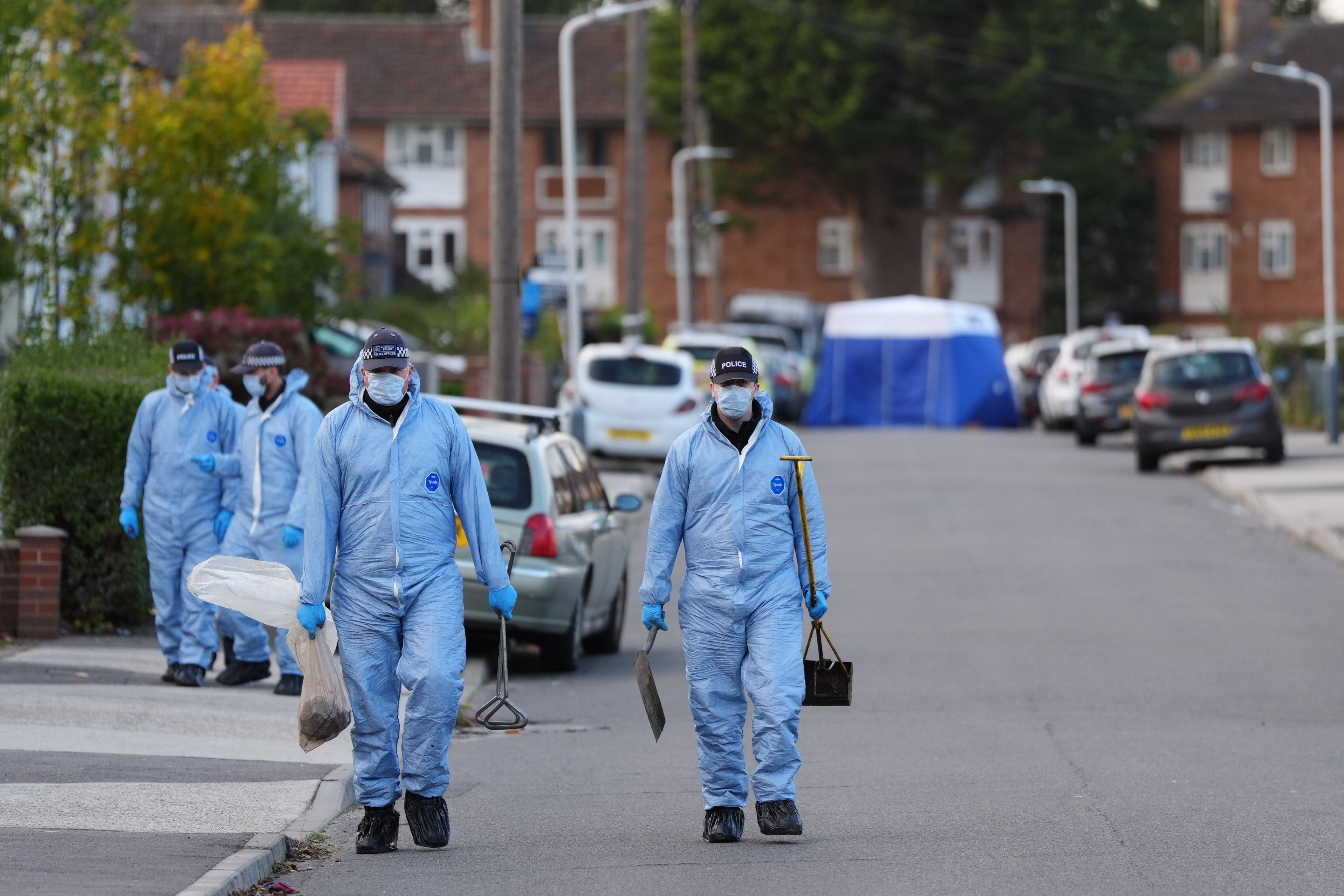 Forensic officers pictured on the street