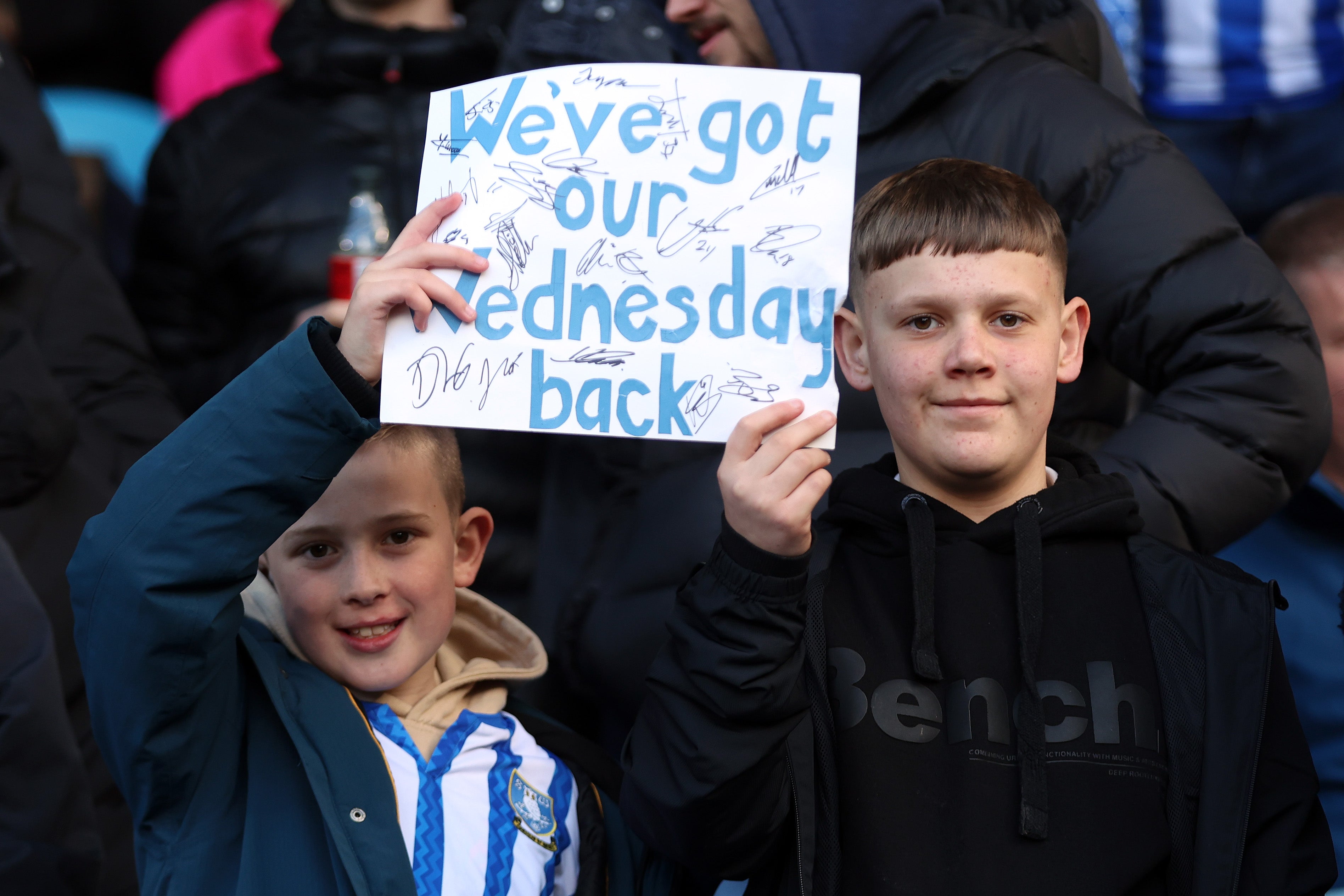 Fans of Sheffield Wednesday show their support with a sign reading 'We've got our Wednesday back'