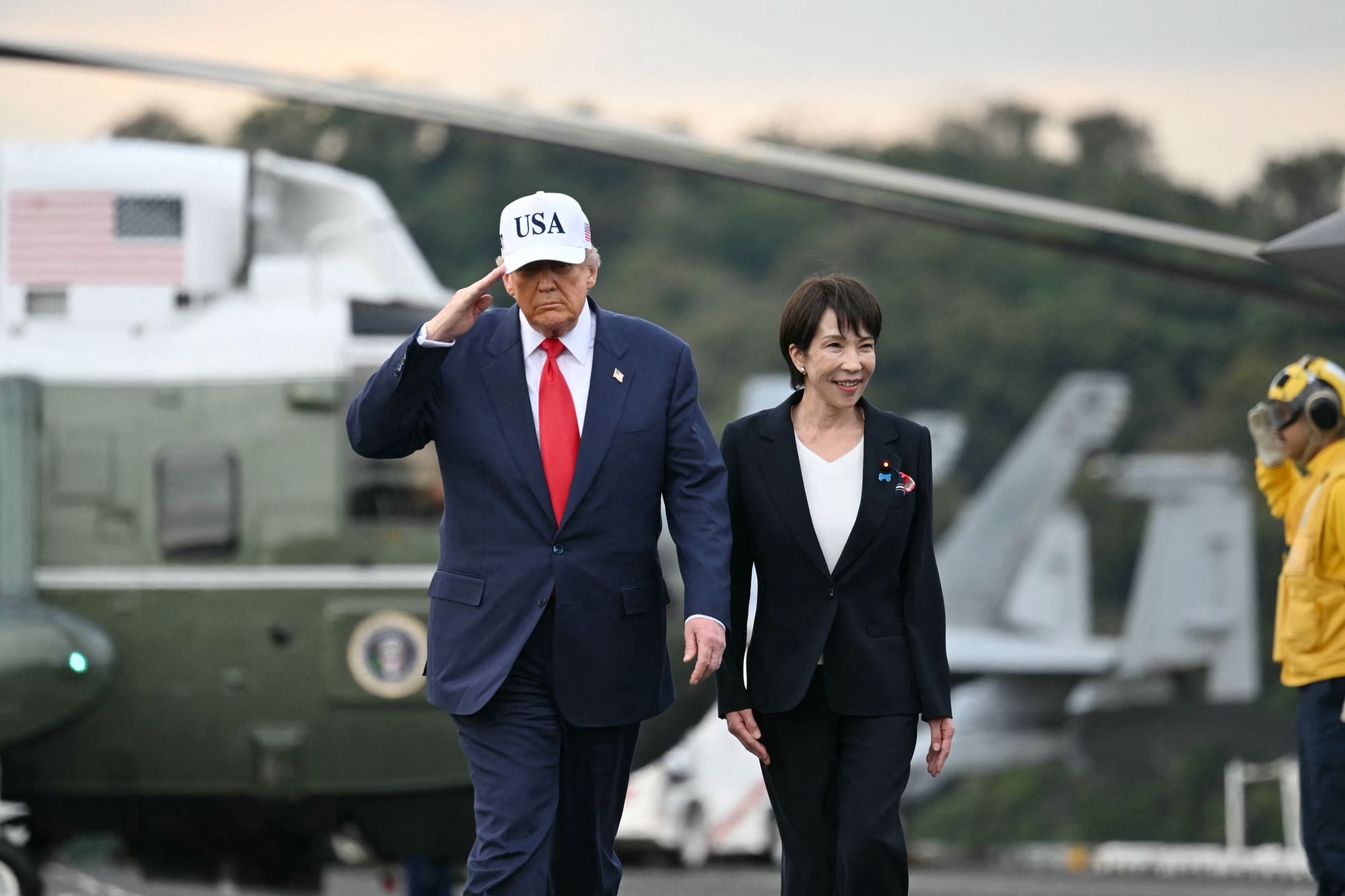 US President Donald Trump and Japan's Prime Minister Sanae Takaichi arrive on board the US Navy's USS George Washington aircraft carrier at the US naval base in Yokosuka
