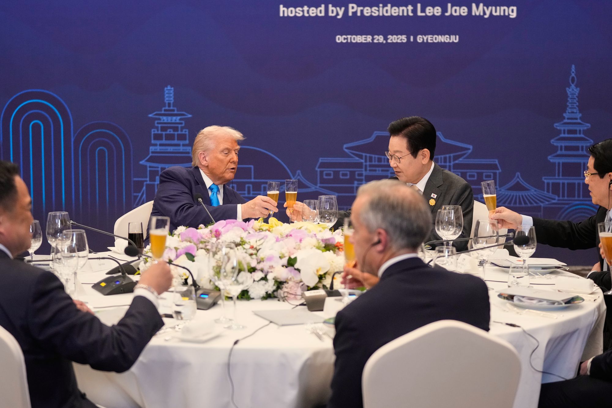 President Donald Trump toasts with state leaders including South Korean president Lee Jae Myung during a dinner event in Gyeongju