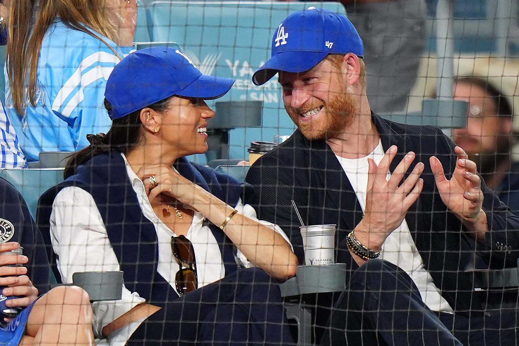 Harry wore a blazer jacket over a white top, while Meghan wore a white blouse with a navy jumper draped over her shoulders (Frank Gunn/The Canadian Press via AP)
